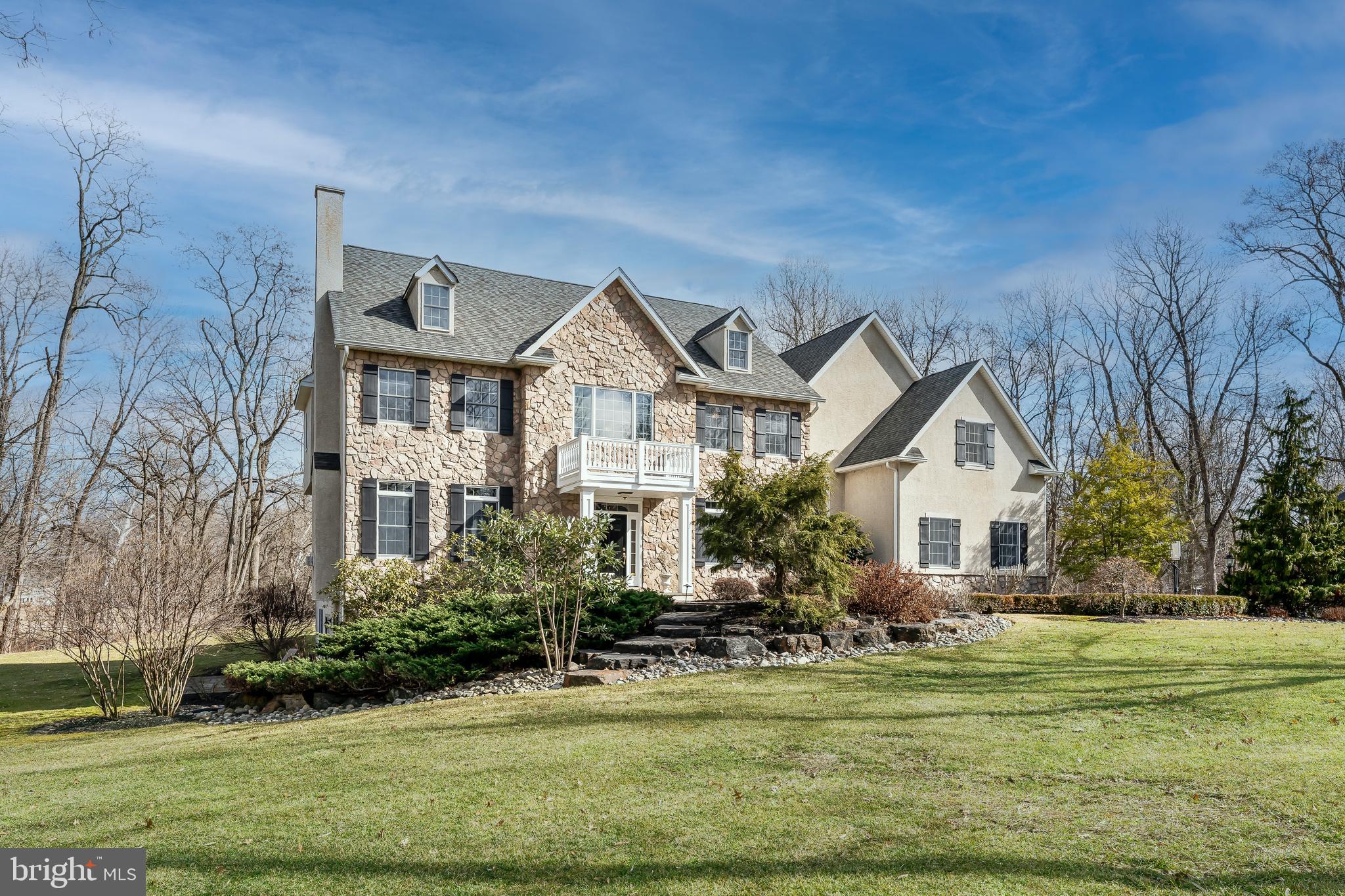 A magnificent custom home on more than two professionally landscaped acres in coveted Buckland Farms, perched high above the Delaware Canal with a gorgeous backyard that offers a rare level of privacy and tranquility. Thoughtful architecture creates a sense of openness and space from the moment you enter the grand two-story foyer, with an inviting sitting room with gas fireplace on one side and a formal dining room on the other. Straight ahead, a soaring stone gas fireplace draws you through to the family room, where the home’s classic design comes into focus: beautiful windows, a cathedral ceiling, gleaming hardwood floors, and an elegant wet bar. To the left is a private office or library. To the right, a built-in buffet announces the open-concept kitchen, where the main attraction is its great center island. Topped with a single, three-inch-thick piece of white Calcutta marble, the island not only provides plenty of comfortable seating and under-counter storage, it makes for one incredible food prep area. Completely remodeled in 2017, the kitchen also features countertops of leathered black granite and heavy, custom millwork. The refrigerator, freezer and gas range are by Thermador; the oven, microwave and dishwasher are all Bosch. There is ample storage space in two walk-in pantries. Beyond the kitchen is a spacious laundry/mudroom with white quartz countertops, additional custom cabinetry, a GE front-loading washer/dryer duo, and easy access to the 3-car garage. Upstairs you’ll find the spacious principal suite, which includes a sitting area and two large walk-in closets. The beautifully renovated principal bath boasts a glass walk-in shower, a soaking tub, and dual vanities topped with white macaubus quartzite. There are four additional bedrooms on this level: two are divided by a Jack-and-Jill bath while the other two share a full hall bath. In the finished lower level, 8 ft ceilings, plenty of windows, and a glass slider to a side yard and patio create a bright and inviting place for a home entertainment center, game room or play area. There’s also another private office/studio space here, along with a separate unfinished area for mechanicals and extra storage. Off the kitchen, a maintenance-free Trex deck and hot tub make for the perfect spot for entertaining friends and family. The private backyard is a nature-lover’s paradise, with endless opportunities for bird-watching. This unique property extends to the canal, offering beautiful year-round views of the canal towpath and the open, natural space beyond. Just minutes to New Hope or Newtown, PA, with fine dining, shopping and numerous state parks, and an easy commute to Princeton, Philadelphia and New York City. HSA Home Warranty- Buyer coverage included. (Taxes appealed- 2022 will be $13,026.63)