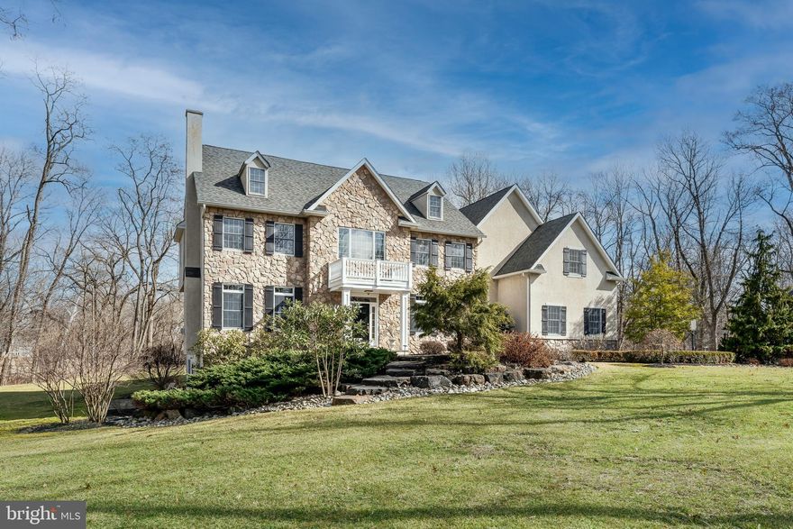 A magnificent custom home on more than two professionally landscaped acres in coveted Buckland Farms, perched high above the Delaware Canal with a gorgeous backyard that offers a rare level of privacy and tranquility. Thoughtful architecture creates a sense of openness and space from the moment you enter the grand two-story foyer, with an inviting sitting room with gas fireplace on one side and a formal dining room on the other. Straight ahead, a soaring stone gas fireplace draws you through to the family room, where the home’s classic design comes into focus: beautiful windows, a cathedral ceiling, gleaming hardwood floors, and an elegant wet bar. To the left is a private office or library. To the right, a built-in buffet announces the open-concept kitchen, where the main attraction is its great center island. Topped with a single, three-inch-thick piece of white Calcutta marble, the island not only provides plenty of comfortable seating and under-counter storage, it makes for one incredible food prep area. Completely remodeled in 2017, the kitchen also features countertops of leathered black granite and heavy, custom millwork. The refrigerator, freezer and gas range are by Thermador; the oven, microwave and dishwasher are all Bosch. There is ample storage space in two walk-in pantries.  Beyond the kitchen is a spacious laundry/mudroom with white quartz countertops, additional custom cabinetry, a GE front-loading washer/dryer duo, and easy access to the 3-car garage. Upstairs you’ll find the spacious principal suite, which includes a sitting area and two large walk-in closets. The beautifully renovated principal bath boasts a glass walk-in shower, a soaking tub, and dual vanities topped with white macaubus quartzite. There are four additional bedrooms on this level: two are divided by a Jack-and-Jill bath while the other two share a full hall bath. In the finished lower level, 8 ft ceilings, plenty of windows, and a glass slider to a side yard and  patio create a bright and inviting place for a home entertainment center, game room or play area. There’s also another private office/studio space here, along with a separate unfinished area for mechanicals and extra storage. Off the kitchen, a maintenance-free Trex deck and hot tub make for the perfect spot for entertaining friends and family. The private backyard is a nature-lover’s paradise, with endless opportunities for bird-watching.  This unique property extends to the canal, offering beautiful year-round views of the canal towpath and the open, natural space beyond.  Just minutes to New Hope or Newtown, PA, with fine dining, shopping and numerous state parks, and an easy commute to Princeton, Philadelphia and New York City.    HSA Home Warranty- Buyer coverage included. (Taxes appealed- 2022 will be $13,026.63)