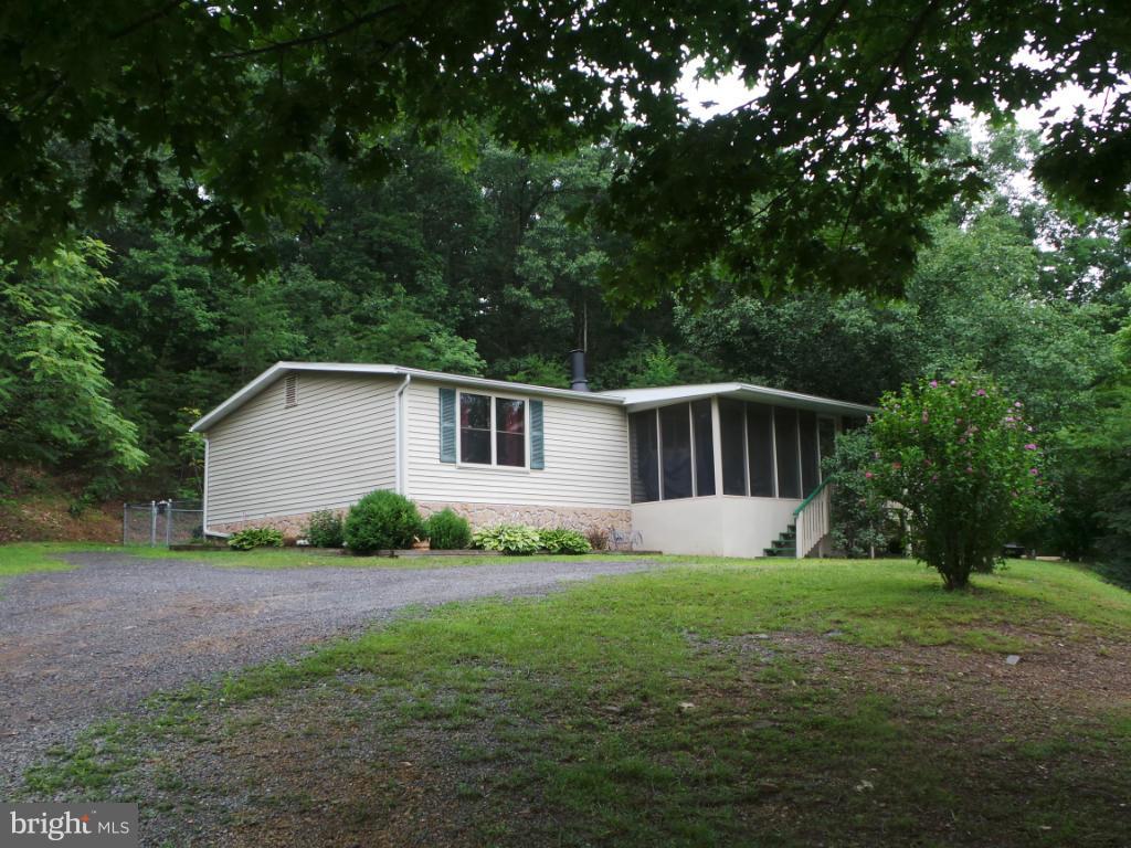 Back on the market with a price reduction! Sooo Why pay rent? Be your own landlord & live cheaper in your own home. This well kept home sits on unrestricted land with 4 bedrooms, 2 1/2 baths & A lot of space for your growing family. If looking for convenience then here it is, only minutes to Berkeley Springs with easy access to 522. Fenced in back yard for your pet and a screened in porch for you