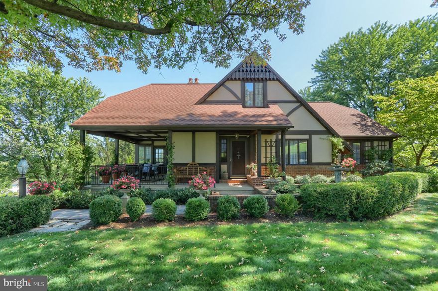 Stunning is the first word that will come to mind when you step through the front door of this gorgeous 
 English Cottage home.  This lovely home includes five bedrooms (could be more) and three full baths and one half bath.   To add to the beauty and charm of this home are the Wide Soft Wood Plank  floors running throughout the house, a  beautiful staircase that radiates character and charm, as well as many built ins that just flow throughout this home.    We also have angled walls, rustic exposed beams and crown molding in many  rooms along with all the beautiful woodwork.   There are 3 levels to this home, the main level boasts a gorgeous Living Room with a wood burning fireplace, massive built in bookcases, a sitting room with a window nook, a great place to curl up and read a good book.    There are 2 bedrooms on this level, one is being used as another sitting room to relax and watch your favorite show, as well as 2 full baths.   Then you walk into the quant kitchen with the 1920 farmhouse stove (which can be replaced with the gas stove - owners have provided already).    Step down to the Formal Dining Room with the streaming morning sunshine throughout the day, then you can step out from the French doors to a relaxing day or evening on the covered porch as you watch the sun set, and then see the sun rise in the morning.    The 2nd floor boasts another bedroom with attached half bath, and the sitting room/loft/balcony (it is JUST GORGEOUS) and is another great place to relax and unwind in this lovely home.    As well as living space on this floor, there is also Attic space for all your extra storage needs.    Now I invite you to the lower level of the home.     This could be an In-Laws Quarters, College Kid very own place, or just use as an extra living space and it has it's OWN ENTRANCE.  The 2nd kitchen includes a 2nd appliances of everything, dishwasher, stove, refrigerator (in this home there are 2 of everything).    Walk into your 2nd Living Room with the rounded corner fireplace.  This floor also boasts 2 bedrooms, one of the bedrooms has french doors that lead out to your very own patio and sitting areas, it also has  a laundry room and full bath (claw foot tub) and so many storage areas (you will not have any trouble finding a place for everything in this home).    Can it get any better, well yes it can ---- The exterior is just as beautiful as the interior, which you will see by the professional landscaping and various gardens and  sitting areas to relax and enjoy your new home.  There is nothing not to absolutely love  about this home, so book your showing today.   If you have questions, please contact listing agent.