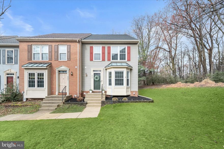 Beautifully renovated end-of-group townhouse nestled against a serene wooded backdrop, offering privacy and one of the nicest lots in the community. Thoughtfully updated throughout with new flooring, fresh paint, stylish fixtures, and more, this home showcases modern living at its finest, highlighted by a stunning high-end kitchen and a truly luxurious primary bath.  The bright and airy open floor plan features hardwood flooring throughout the main level and a bi-level living and dining room offering seamless access to the expansive deck overlooking trees. The renovated kitchen is a showpiece, complete with a center island, bay window breakfast nook, striking granite countertops, custom cabinetry, and stainless steel appliances. A convenient powder room completes the main level.  Upstairs, the impressive primary suite boasts soaring vaulted ceilings, a customized walk-in closet, and a spa-inspired en suite bath featuring a soaking tub, dual granite vanity, and a frameless glass shower with both rainfall and handheld showerheads. Two additional bedrooms, each with vaulted ceilings and loft storage, along with an updated hall bath, complete the upper level.  The finished lower level provides additional living space with a spacious family room providing walk-up access to the backyard. A large laundry/utility room includes a custom built-in workshop and utility sink for added functionality. A floored stand-up attic offers excellent storage.  Additional major updates include a roof replacement (2019), new water heater (2026), AC unit (2024), gutters with helmet guards (2017), and a sump pump (2022), providing added value, efficiency, and peace of mind.  Enjoy outdoor living on the expansive deck with peaceful, tree-lined views, perfect for relaxing or entertaining. Community amenities include a tot lot, and the home is ideally located near major commuter routes with easy access to shopping, dining, and entertainment.