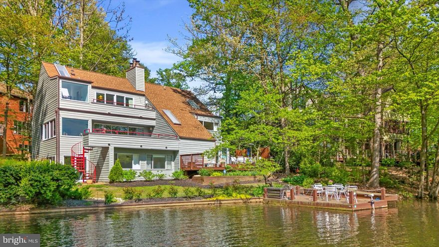 OPEN HOUSES - SATURDAY MAY 4 - 1-3 PM  &  SUNDAY MAY 5  2-4 PM

Not looking to move?... Betcha this house will change that.

Experience modern elegance and prime waterfront living at its finest at 2002 Cutwater Court in Reston, VA. This stunning light-filled contemporary home built by Abrash and Eddy boasts 4/5 bedrooms, 3 bathrooms, and  2000 square feet of elegant living space on a generous 0.27-acre lot overlooking the serene Lake Thoreau.

Step inside to discover a well-maintained interior with new paint throughout, accentuating the sleek hardwood floors and high ceilings. The unique layout spans 6 half levels, offering an abundance of architectural charm and versatility with curved walls and striking angles. The main level features a sunlit living room with a sprawling balcony, providing breathtaking views of the lake.

Make your way below to discover the dining area, with lofty ceilings and skylights, alongside the updated kitchen revamped in 2021, featuring pristine white cabinets, quartz countertops, and sleek stainless steel appliances. Floor-to-ceiling windows and skylights flood the space with natural light throughout. Entertain in style on the deck, perfectly positioned for enjoying the tranquil waterfront setting, complete with a private dock as well as a floating dock for easy lake access.

The primary bedroom is a true retreat, a boasting vaulted ceiling, a private balcony and a wood burning fireplace with an antique wood mantel while the en-suite bathroom showcases a soaking tub with a picturesque view of the lake. A landing overlooking the dining room adds an extra touch of sophistication to the home's design.

The lower level walkout beckons with a cozy recreation room boasting a wood-burning fireplace adorned with an antique mantel. Additionally, it features a spacious 3rd bedroom that can easily be reconverted into 2 if needed, with a recently renovated full bath equipped with a shower. Step into the sunroom from the recreation room, which seamlessly transitions to the side garden. Embrace your green thumb with the raised flower bed adjacent to the charming brick patio.

Outside, the newly painted exterior and newer roof enhance the property's curb appeal, complementing the contemporary architecture. The mature garden has a sprinkler system, extensive hardscaping and landscaping of colorful shrubs, trees, and manicured flower beds,  a tiered deck with a tranquil water feature, and a floating dock that can be motored out on the lake - all creating a haven for outdoor living and entertaining.

Look no further for an enduring investment in a vibrant location with this stunning home. With only 1 mile to Wiehle-Reston Metro and less than 10 miles to Dulles Airport, quick and easy access to major routes and highways (267, 66, 495), this home offers a rare opportunity to indulge in modern elegance and lakeside living near our nation's capital, Washington DC. Come live your best life on Lake Thoreau!