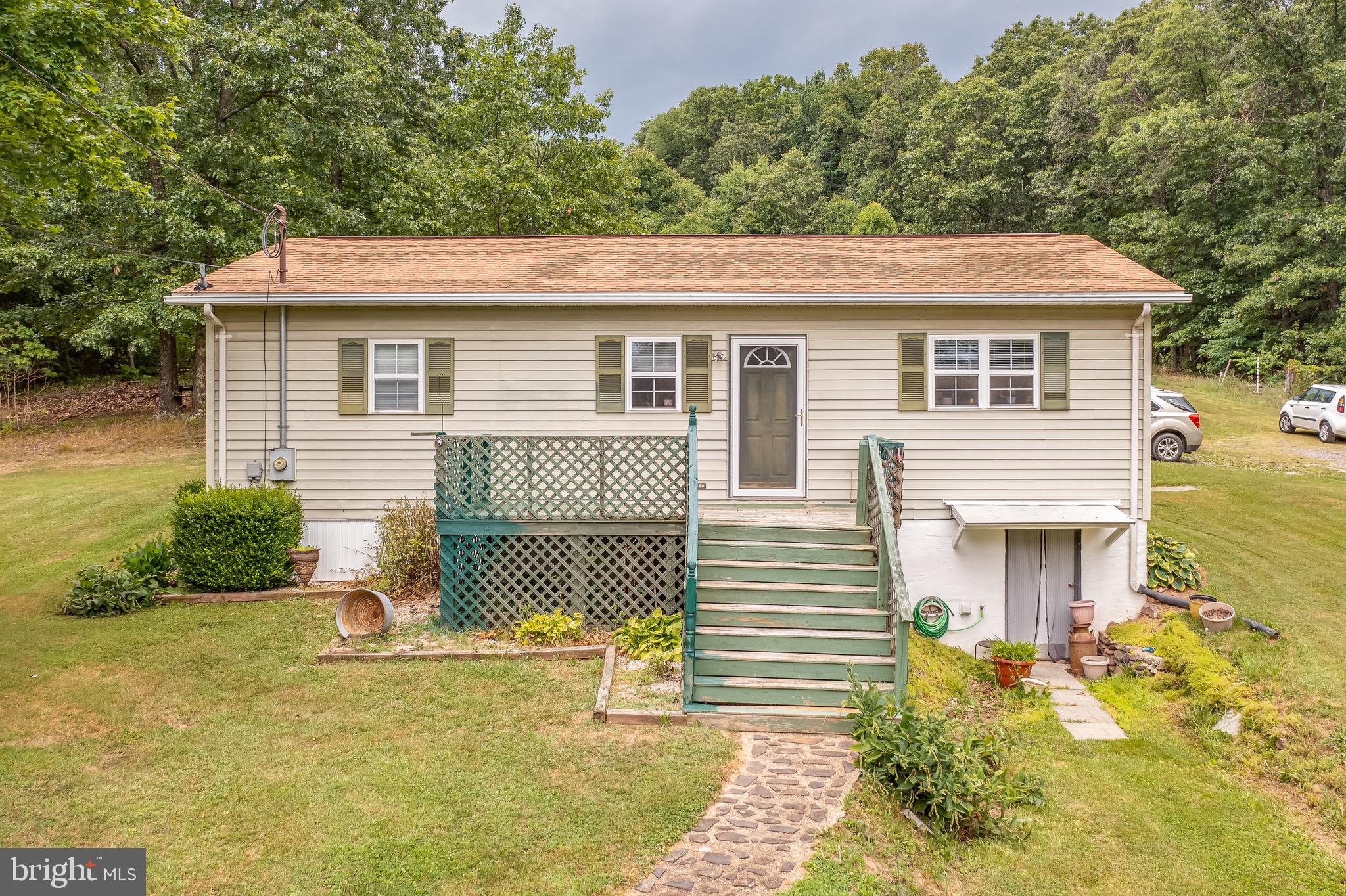 Beautiful rancher on 4.71 UNRESTRICTED acres overlooking the mountains is now ready for a new owner! Home has been VERY well maintained. All appliances stay except downstairs refrigerator. There is a fairly new washer and dryer, 2 window AC units with remotes. Bedrooms have large closets for storage. Kitchen has a small breakfast area with an open floor plan throughout the rest of the home. Basement can be finished. Featuring an above ground pool with plenty of yard space, this is a great place to gather and entertain. Peaceful backyard including beautiful landscaping & flower beds. Large back deck partially covered, 24X24 storage shed, long gravel driveway for parking. This cozy home tucked away in the woods gives you privacy but still located within 3 miles to convenience stores and Winchester is a 30 minute drive away. Perfect for a starter home or a last home!
