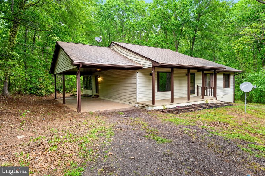 Adorable Ranch/Rambler on 2.69 acres. Lots of windows!! Granite countertops, stainless steel appliances and a kitchen island, perfect for entertaining. Beautiful sunroom with a great and relaxing view to the outside. Master suite has new carpet and a newly updated bathroom with a walk in shower, new floor tiling, vanity and fixtures. Second bathroom has also been updated. Attached carport to the home. The property is beautiful with lots of quiet, outdoor space.