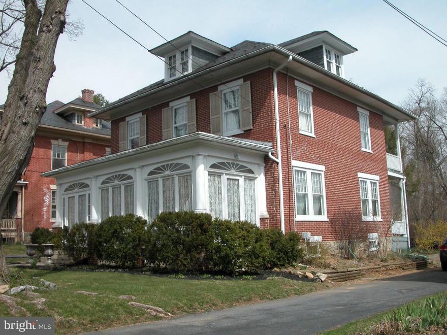 Enchanting 2 1/2 story spacious brick home. This beauty is in superb condition with gorgeous hardwood floors and original chestnut woodwork throughout.  Enclosed porches, brick patios, a private balcony, & a grand foyer are among the unique characteristics of this charming Victorian style home. Other appealing features include original french pocket doors, built-in dining room cabinet and wooden columns, & a cozy gas fireplace. Just spectacular!
