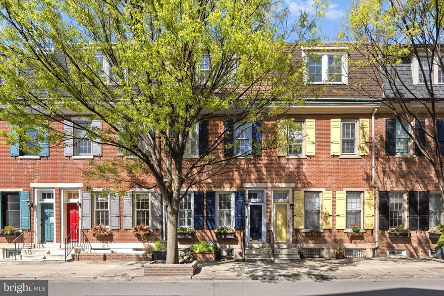 Beautifully maintained Washington Square West home with gated PARKING included, just steps from front door. Inviting curb appeal with classic brick facade, painted wood shutters, and window box planters. Enter into a bright entryway with high ceilings, wainscoting, a graceful staircase, and a large coat closet to the right of the kitchen. First floor features a recently renovated kitchen complete with stainless steel appliances, quartz countertops, wood cabinetry, and tile backsplash. The kitchen opens to a generously sized dining room with a working fireplace and french doors leading to the lush private garden patio. Natural light pours through the oversized front windows and rear door of this first floor! On the second floor, you’ll find a bright and spacious living room with high ceilings, built in bookshelves, and a large bay window overlooking a captivating courtyard. This floor is complete with a  full bathroom that was completely renovated with marble tile and glass shower doors on the standing shower. The third floor is home to two generously sized bedrooms both with great closet space, ceiling fans, and plenty of natural light, and a center hall bathroom. The basement offers plenty of extra living space  and the versatility to serve as a media room / den, or home office, with separate space for laundry and additional storage.  Truly in the heart of everything, the location couldn’t be better and the home boasts a WALK SCORE of 99/100!!. Enjoy being just footsteps from fabulous restaurants, shopping on Antique Row, performances on the Avenue of the Arts, Whole Foods, and so much more. Just steps away from Seger park which is fitted with a playground, dog park and tennis courts and a short walk to other city parks such as Hawthorne Park. If you don’t feel like walking, take advantage of easy access to public transit (Septa Bus runs straight down Lombard street), and of course, your own parking space in a gated lot just feet from your front door. You won't want to miss this one!
