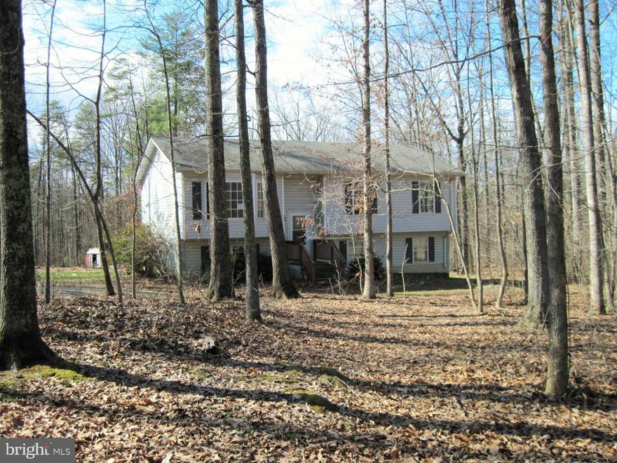 INVESTOR SPECIAL...Lots of potential!  3 BR/2BA home on 5 acres in a quiet rural community with no HOA.  The lot is mostly wooded, but has a large cleared back yard.  Unfinished walkout bsmt has potential for 4th BR and full bath.  Space for a family room too.  Lots of work!  Cash or Conventional buyers only.  Property being sold strictly 'as is'.  Subject to 3rd Party Approval.