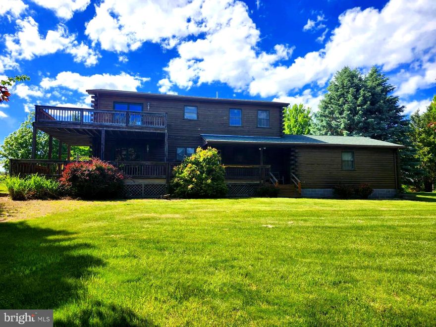 FEAST YOUR EYES ON THIS! A GORGEOUS (1960 SQ FT) CUSTOM LOG HOME WITH A MILLION DOLLAR VIEW! THIS PROPERTY IS METICULOUSLY LANDSCAPED  WITH A TREMENDOUS VARIETY OF TREES AND SHRUBS, AND OFFERS YOU ONE OF THE MOST BEAUTIFUL VIEWS YOU COULD POSSIBLY FIND.  THIS HOME WAS BUILT IN 1991 AND HAS SOME ABSOLUTELY GORGEOUS CUSTOM WOODWORK, LAMINATE PLANK FLOORING, TONGUE AND GROOVE FLOORING,  EXPOSED BEAMS, LOG WALLS, SKYLIGHTS, AND A BEAUTIFUL STONE FIREPLACE! EVERYTHING IN THIS HOME WAS TASTEFULLY FINISHED. THE HOME ALSO HAS A TWO CAR ATTACHED GARAGE. THE PROPERTY SITS ON LOT #99 (3.17 AC.)  IN HIGH MTN. ORCHARD AND HAS AN ADJACENT LOT WHICH IS AVAILABLE AS WELL LOT #98 (3.18 AC.) THERE ARE 3 ROOMS THAT HAVE NOT BEEN COMPLETED AS YOU WILL SEE IN THE PHOTO'S. THE LAUNDRY ROOM, AND THE UPSTAIRS BEDROOM AND BATHROOM HAVE NOT BEEN COMPLETED. THE HOME OPERATES OFF OF A CISTERN AND PRIVATE SEPTIC SYSTEM. THE WATER CISTERN IS AN 1800 GALLON TANK WITH A BRAND NEW PUMP. THE SHINGLE ROOF WAS REPLACED IN 2015, THERE IS A WRAPAROUND DECK COVERING 3 SIDES OF THE HOME, THE DECK COULD USE A LITTLE SPRUCING UP. DON'T WAIT AROUND, THIS HOME HAS TONS OF APPEAL, YOU MUST SEE THIS HOME TO APPRECIATE ALL THAT IT HAS TO OFFER!