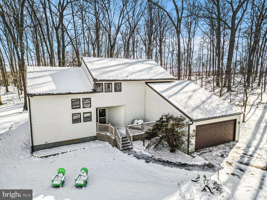 Set on a 2.47 acre wooded lot, this 2,500 sq. ft. contemporary home offers privacy, quiet surroundings, and a layout that fits the rhythm of everyday life. The main level features an open concept design that begins with a bright gourmet kitchen, complete with 42" maple cabinets, Silestone quartz counters, an island, and generous cabinet and counter space. The kitchen opens to a cozy family room providing an easy place to relax, catch up on shows, or stay connected while cooking. A separate dining room sits just off the kitchen, making weeknight meals and gatherings simple and convenient. The living room adds another inviting space and features a woodstove that brings warmth and charm during the cooler months. A main-floor bedroom/office adds flexibility for guests, work, or hobbies. Outdoor spaces are a natural extension of this home. The screened-in porch offers a quiet place to enjoy the wooded setting, and the maintenance-free rear deck overlooks the trees for year-round views. A maintenance-free front porch provides another spot to slow down and take in the surroundings. Upstairs, you'll find three additional bedrooms, two full baths, and a convenient upper-level laundry, keeping daily tasks simple and accessible. The oversized one-car garage offers extra storage, and the property includes a 16' x 32' workshop with electric, ideal for woodworking, equipment, or additional workspace. The partial basement with ceramic tile floor provides even more storage options and room for organization.
Important updates include the roof (2020), heat pump and outside condenser unit (2008), well holding tank (2025), and hot water heater (2020), Mitsubishi mini-split in Primary BR (2023).  Shed on the back of the property is being sold strictly AS IS.
