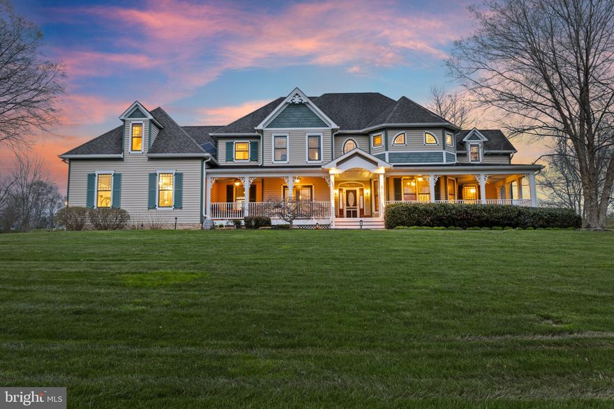 Welcome home to halcyon! The approach from the base of the driveway opens up to reveal a stunning vista - a statuesque custom-built Victorian, replete with inviting wrap-around front porch and gorgeous Victorian detailing - perfectly poised in the center of a serene nearly 5-acre lot and overlooking its own pond! The interior offers high ceilings, gleaming hardwood floors, abundant natural light and generously-sized living spaces. The heart of the home is a cleverly-designed space that unites the large gourmet kitchen, breakfast area and appealing family room to create a large, open gathering place for family and friends, featuring desirable appointments like a wine fridge and small wet bar to enhance your entertaining! The sprawling upper level boasts a primary owners' suite with dressing room and luxury spa bath, 2 well-proportioned bedrooms and a fabulous bonus room that will accommodate any use you desire. The recently finished lower level is remarkable - with custom fabricated reclaimed wood accents, a Gramophone sound system, media area, billiard area, impressive fully appointed wet bar plus full bath and 5th bedroom, you won't be able to wait to hang out here! If al fresco entertaining is more your style, you will want to spend all of your time on the lighted rear stone terrace  hosting summer bbqs listening to your favorite music via the exterior speaker system or reclining at the recessed fire pit, soothed by the calming sounds of the built-in waterfall feature and surrounding nature.  You deserve to truly love where you live!