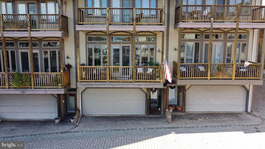 This home is located in the gated waterfront condo community of Chesapeake Harbor where residents enjoy a host of amenities, including two pools, a private beach, two fishing piers, kayak storage, jogging paths, a gym, a marina, tennis and pickle ball courts, and an on-site waterfront restaurant. This home boasts two bright, spacious bedrooms, a living room with high ceilings, a gas fireplace and a wall of windows with a french door leading to a relaxing deck. The generous kitchen features updated stainless appliances, and the two-car garage with additional crawl space that offers plenty of storage. With new floors and fresh paint throughout, make it move-in ready and truly complete!  Conveniently located near public transportation and major commuter routes, providing easy access to downtown Annapolis, NSA/Fort Meade, Washington, D.C., and Baltimore City, as well as shopping and recreational activities.  Professional pictures and Matterport 3D tour will be available by the end of the week.