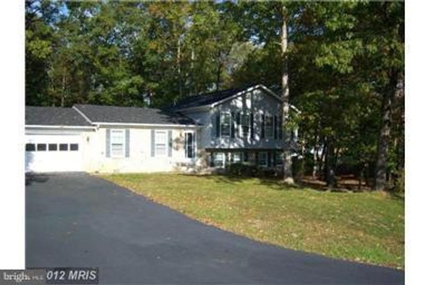 Short sale approved if able to settle quickly.  Home has great potential and needs some work (paint and carpet).  Great space in this split level with 2 car garage, fireplace, hard wood flooring, rear deck, expansive back yard and finished basement.  Sold strictly as is.  All terms subject to 3rd party approval.