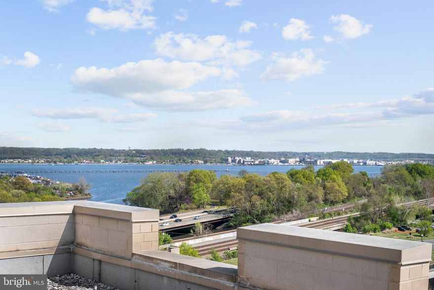 Open Saturday and Sunday, 11am-1pm!

Welcome to #1050, a rarely available, stunning two-bedroom, two-bathroom corner condo with one of the largest private rooftop terraces at The Eclipse. This impressive upper floor unit boasts south-facing views of the Potomac River and Potomac Yard, the George Washington Masonic National Memorial, and National Harbor; it’s an incredible opportunity to have a river view for under $800,000 in National Landing. Brazilian cherry floors are found throughout, while near floor-to-ceiling windows flood the home with natural light. The gorgeous, renovated kitchen features granite countertops, dark wood cabinetry, a beautifully tiled backsplash, and stainless steel appliances; it opens to a unique den space, perfect for an extra dining area or home office. The expansive living area provides ample room for entertaining, and connects to a balcony that overlooks the center courtyard. The primary bedroom has an en suite bathroom that was fully redone and features a double-vanity, jacuzzi soaking tub, and separate shower. Off the primary bedroom is the incredible  rooftop terrace, one of just two this size in the East building. It is large enough to accommodate multiple outdoor furnishings. The second bedroom features a built-in murphy bed and huge walk-in closet, as well as custom window treatments. An in-unit washer/dryer, two assigned garage parking spaces and one storage space complete this special offering.

The Eclipse has on-site professional management, a 24-hour concierge, one of the largest condo pools in the area, a well-equipped fitness center, a rooftop deck, community room, and several outdoor gardens. Conveniently located less than a mile from Amazon HQ2, DCA, and Virginia Tech's upcoming Innovation Campus, the building sits between the Crystal City Metro and Potomac Yard Metro. It provides unrivaled access to some of the best Arlington has to offer.
