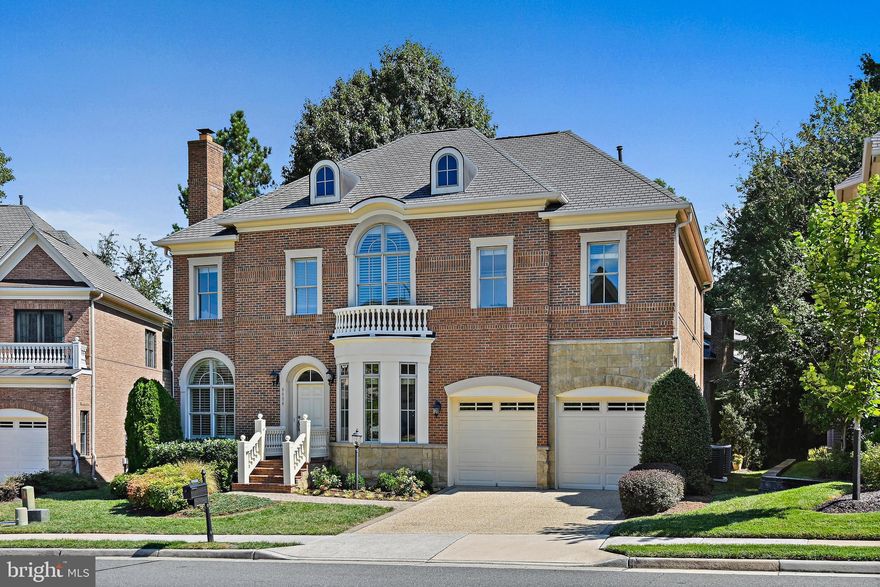 This stunning Ashton Colonial by Van Metre Homes offers over 5400 finished square feet of luxury living in the prestigious cul-de-sac community of Tysons Chase, just one mile from Tysons Corner, the Town of Vienna, Metro, world-class shopping, and major commuter routes.
The home’s elegant design showcases 10-foot ceilings on the main level (9-foot on the upper and lower levels), 3-piece crown moulding, chair rail and wainscoting, and a stately three-sided brick exterior with Arriscraft dimensional stone watertables and Hardi-Plank siding.
The open floor plan features 4” white oak hardwood flooring throughout the main level. At the heart of the home is a gourmet chef’s kitchen with granite countertops, a full-size pantry, stainless steel appliances (Wolf, Sub-Zero, Bosch, GE), 42” maple cabinets, and access to the professionally landscaped backyard with its custom stone patio. The kitchen flows seamlessly into the spacious family room with a natural gas fireplace. A wood-burning fireplace warms the formal living room, which opens to the elegant dining room, while a private office with glass-paneled French doors completes the main level.
On the upper level, discover five generously sized bedrooms. The highlight is the primary suite—an elegant retreat with garden views, its own sitting room, and a spa-like bath designed for relaxation. A large laundry room with sink and built-ins is conveniently located on this level. Two bedrooms share a Jack-and-Jill bath, while the guest suite has its own en suite. The third-level loft/5th bedroom offers a walk-in closet and private retreat.
On the lower level, discover a spacious recreation room with full wet bar, a flexible theater/exercise/office space, and a private sixth bedroom with en suite bath—perfect for an au pair or long-term guest. A walk-up leads to the backyard, while generous unfinished storage with a rough-in for another bath offers room to expand. Steps from home, discover a network of parks and trails, highlighted by the Washington & Old Dominion Trail—perfect for family bike rides, weekend walks, or a scenic trip into downtown Vienna.
Additional highlights include:
•
