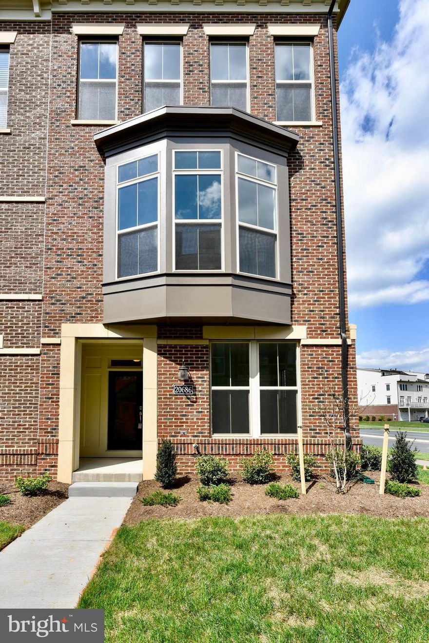 BRAND NEW MILLER & SMITH HOME IN ONE LOUDOUN! 2,373 sq. ft. of living space in an open light-filled floorplan. Quality is evident from your first glance at the architectural details of this contemporary townhome with brick front. Once inside, the first level greets you with 9 ft. ceilings, a roomy foyer, storage room, full bath with shower and family foyer with large closet. Hardwood stairs lead to the main living level which opens up with spectacular 10 ft. ceilings, a gorgeous kitchen with quartz counters, white shaker cabinets, Samsung appliances including 36” cooktop, SS Hood, French Door Fridge and built-in oven & microwave. The huge contemporary island has black cabinets and pendant lighting; walk-in pantry features wood shelves. A stunning dining room showcases tray ceiling and bay window. The private powder room is tucked around the corner, and the impressive entertaining room includes ceiling beams and gas fireplace that opens to a partially covered terrace! A spacious owner’s suite with tray ceiling includes a large walk-in closet with window and a spa-like bathroom that showcases an oversize shower with rain showerhead and full-length seat. Two additional bedrooms, hall bath and laundry room complete the upper level. Enhanced Vinyl Plank flooring throughout 1st two levels & 3rd level hallway; upgraded carpet in all bedrooms. Ideally located at Route 7 & Loudoun County Parkway, living in One Loudoun allows you to enjoy the luxury of having a variety of conveniences, amenities and excitement right at your fingertips. From endless dining options to events nearly every weekend on the plaza or at The Barn, it’s where Loudoun County goes for FUN. If a slower pace is more your style, then One Loudoun’s Central Park offers acres of natural beauty filled with trails, benches and quiet areas. Prefer athletic adventures? The Club at One Loudoun provides a resort style pool with snack bar, 2 tennis courts, a multi-purpose court and large entertaining room and catering kitchen.