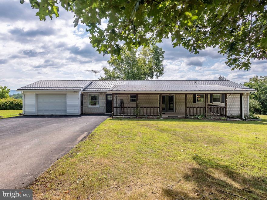 One of the bedrooms was converted to a laundry room when the Mother was unable to do the steps but could be converted back to a bedroom.  One Level living that has been lovingly maintained over the years.  Situated off Winchester grade road with 2 acres for gardening and plenty of room for entertaining.  Full basement that could be finished for added square footage.  Brick hearth and fireplace adds charm to the living room and  large bay window brings in the sunshine.    Not far from downtown historical Berkeley Springs.