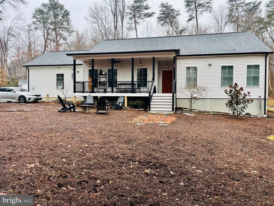 Location, location, location! Just a few minutes from Ft. Meade and NSA; Maryland routes 295, 95, 32, and 100. Close to Arundel Preserve, Columbia, BWI airport, and Jessup park is a .5 mile away. Calling all nature and project lovers, and/or those who are homestead dreaming! 3-year-old modular home (known for their solid construction) enveloped with tree coverage and conservation acreage. This is a gorgeous .92 acre lot with house located 300' off of the main road, offering one of the most private lots in the area for its size. It is homestead-ready with a new Amish-built mini barn and shed, two black chain link fenced areas (we had chickens and goats on one side, dogs on the other) with latch gate connecting the two, inviting front porch and a large partially screened back deck with high-end Jetsetter LX salt-system hot tub. Finished basement, approx 1500 on main (2bed, 2bath) and 1500 on lower (1bed, 1bath). Main Level: double-sided (primary suite & LR) propane fireplace, plantation shutters throughout, gorgeous antique-style large blade ceiling fan in primary, additional ceiling fans (office, L/R, and 2nd bedroom), box ceiling in primary, sliding glass doors off of primary bedroom offer beautiful view of trees and walkout access to hot tub, artisan clay tiles in kitchen, quartz kitchen countertops and copper sink, french glass doors for office (perhaps use as extra bedroom or dining room), two separate vanities/sinks in primary bath, large shower with clay tiles, large walk in closet attached/behind primary shower, 2nd bathroom has tub/shower, laundry room with sink, open kitchen and L/R area with high counter bar with dark copper L-brackets, wide garage. Basement: a separate front entrance, perfect for an additional dwelling, home gym/exercise space, and/or a home business. Lower was used as dance studio space and massage room, has floating/sprung floor and mirrors along two of the longest walls, and installed curtain tracks to divide areas if desired. Brass sink vanity in bathroom, copper shower basin, clay floor tiles, plenty of closet/storage space. Exterior: drink your morning coffee/tea and watch deer from the front porch as they cross the 300' gravel driveway and opposite side of the property, lots of guest parking, circle drive option around biogarden, black gutters and downspouts, 50 amp installed for RV and septic drop, lavender garden, fig tree, two weeping willows, yews, berry vines and bushes, butterfly garden that brings in annual monarchs, bat house and family of bats that are pure joy to watch circle the property as the sun sets, extra large hostas, small veg garden, compost area, etc.,..and there is lot of empty space to work with to make it your own oasis. Serious interest only, and must be able to pay the difference, out of pocket, between appraisal and purchase price which might be approximately 50-75K. Home sold as is, asking price is the exact combined purchase price for home and land. more photos and a video to come