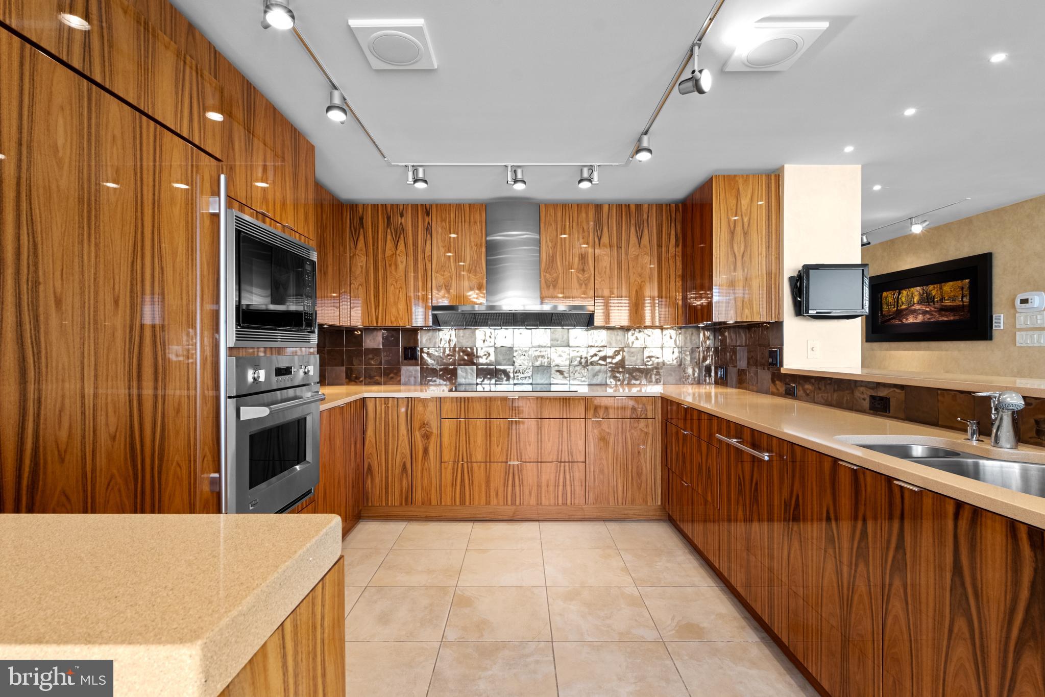 Exceptional residence spanning nearly 4,000ft2 on the 20th floor of Independence Place Condominium on Washington Square Park. Several units were gutted/combined and completely reimagined as this one-of-a-kind home. Floor to ceiling windows and three exposures (South/East/North) allow for incredible natural light and panoramic views. Flexible, open floor plan designed for both larger scale entertaining and more casual, everyday living. The most extraordinary features/finishes throughout, including venetian plaster walls, custom cabinetry, millwork, lacquered wood paneling, doors/trim, integrated lutron lighting system, and recessed baseboard detail. Gallery entry opens to custom kitchen w/ every conceivable amenity:counter seating for four, custom cabinetry, Wolf induction cooktop, paneled subzero refrigerator, metallic Walker Zanger tiled backsplash, breakfast area w/ built-in banquette, and separate office nook. Ktichen opens to dining and living spaces with South and East views, corner fireplace, and wet-bar/walk-in pantry area with under-counter wine storage and refrigerated drawers. Down the hall, two well proportioned bedrooms share a newer, contemporary hall bath. The over-the-top primary suite is outfit with custom furnishings to accentuate southern views, a second fireplace, and features two walk-in closet/dressing areas, two natural stone clad en suite bathrooms w/ steam shower, jetted tub and frameless glass enclosures, a separate lounge area, and an additional gym/studio space with sauna and kitchenette. Thoughtful laundry area w/ full size, side-by-side machines and custom cabinetry is cleverly hidden behind a sliding door system. Private terraces off the living space and primary suite. Remote controlled custom window treatments and Sonos audio throughout. No expense was spared, and every detail has been thoughtfully considered in design/construction. Residents of Independence Place enjoy 24-hour door staff and concierge, newly redesigned lobby, state-of-the-art fitness center, and on-site parking garage with direct lobby access (additional monthly fee). Close proximity to Philadelphia's premier dining, shopping, lifestyle and cultural institutions. Easy highway access into/out of the city.