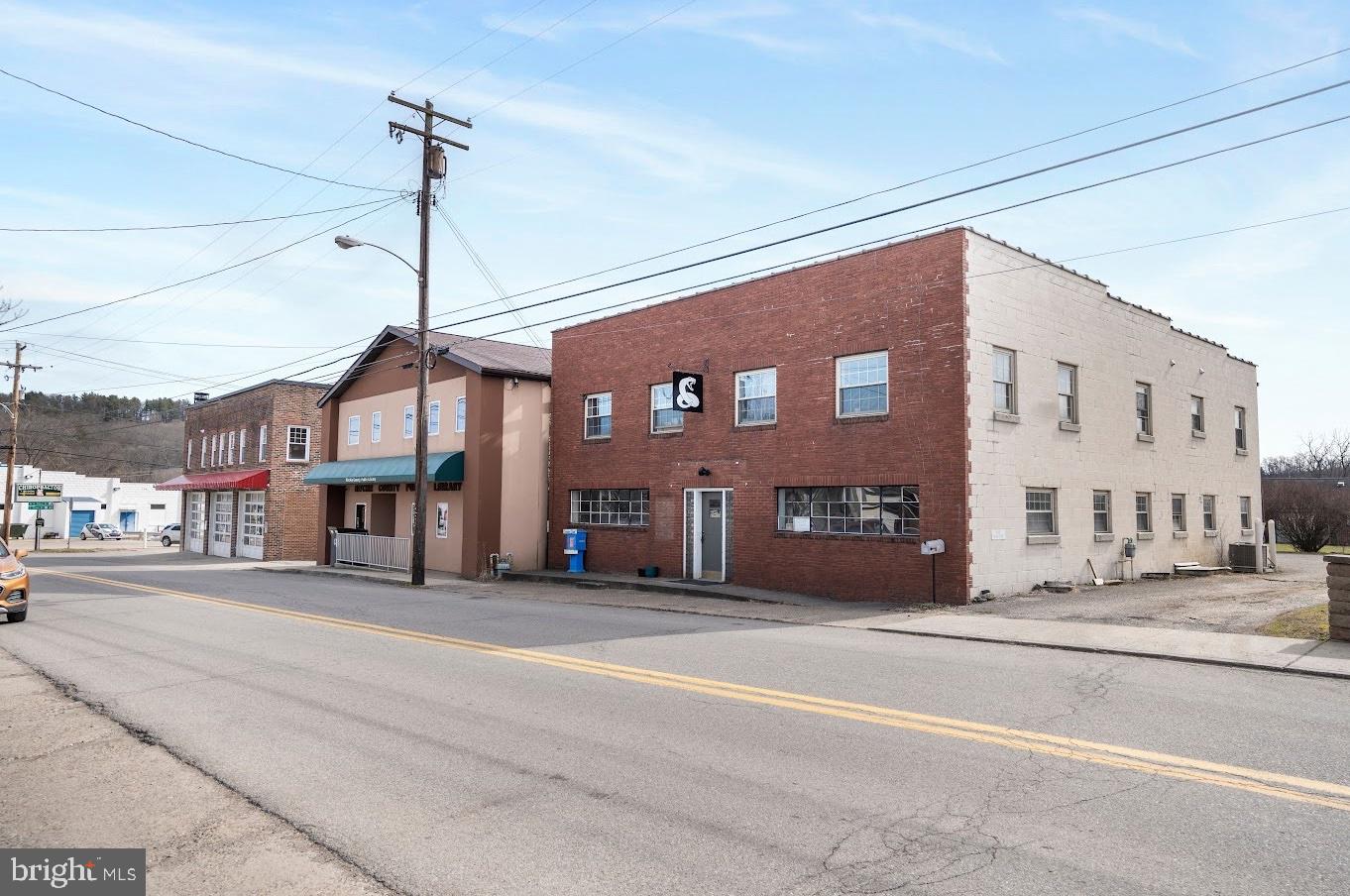 This is a great opportunity for multi-use commercial space with current residential income in place. With nearly 5,000sqft, this commercial building is on the main street in the town of HARRISVILLE. Featuring $125,000+++ of updates with the 2 upper level apartments completely remodeled. Apartment #1 has 3 bedrooms, living room, kitchen with 1 full bath. Apartment #2 has 2 bedrooms, living room, kitchen with 1 full bath. Both units have laundry on site. The apartments are tenant occupied providing immediate income opportunity. The entire lower level is commercial office space, previously a medical office with potential to be used for a salon, shops, medical or other professional office services. This space has 10 small rooms, 4 large storage closets, a utility room, 2 showers plus 3 half baths. additional kitchen and garage. Plenty of parking, Great location! So much potential! Call for a tour. Accepting Back up Offers
