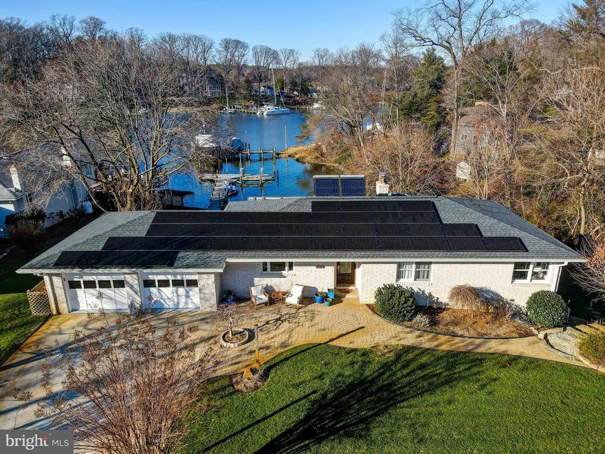 Exceptional waterfront rancher in St. Margaret's with protected, deep water on Burley Creek.  Enjoy your own private pier,  boat lift and large slip providing easy access to the Chesapeake Bay.  80 feet of water frontage and 6 feet of MLW this location is a dream for boating enthusiasts.  Step inside an open floor plan which includes a family room, dining room and kitchen with water views.   A brick fireplace and wood mantel anchor the family room providing the perfect backdrop for watching sunsets.  Renovated kitchen with granite and quartz counters, stainless appliances, Thermidor speed oven, convection oven, induction cooktop, Samsung refrigerator and wine fridge.  Easy flow of movement throughout the home with main level primary suite and a renovated primary bath with panoramas of Burley Creek.  An abundance of livable space on the lower level with entertainment area, brick fireplace, coffee bar, and refrigerator.  Possible third bedroom or home office and well-appointed full bath.  Wine cellar, storage space, washer, dryer and walk-out stairs offer easy access to the water.  Power and water located on the pier.  Relax by a fire pit in the backyard or on an expansive deck with multiple seating areas.  Live sustainability with a fully owned 13Kw solar panel system, solar hot water and a 13KW generator to run the whole house. 2023 Culligan Reverse Osmosis water treatment system.  Climate controlled 2 car garage with storage room and paver driveway with storage for a watercraft.  Voluntary HOA ($50/year) with park access, community dock with slips, playground, picnic area and kayak racks.  Progressive dinners and quarterly parties.  Located just a quick boat or car ride from downtown Annapolis.  Don’t miss an opportunity to live on the water in this fantastic neighborhood!