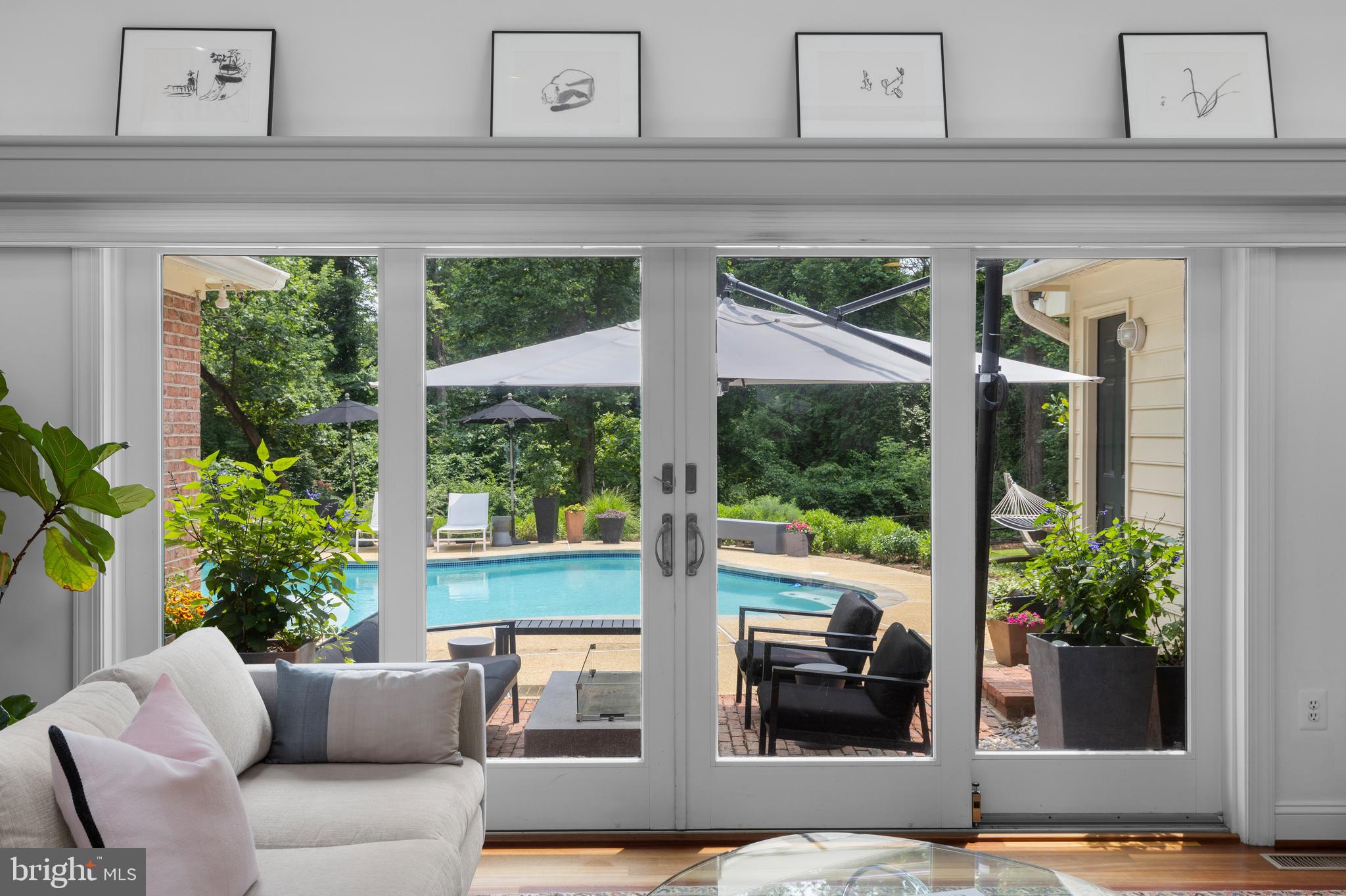 Tucked away beyond the busy streets, Eaton’s Landing offers a serene retreat on a picturesque peninsula surrounded by water. This custom-built home with remodeling updates and additions by the late renowned architect Peter Andrews, with 6 bedrooms and 4.5 baths showcases timeless quality and design. Sited on a 40,890 sq. ft. corner lot, the property features an inground, Gunite pool with spacious pool deck, multiple exterior patio areas, lush landscaping and an oversized two-car garage. Enjoy entertaining year round by the southern oriented pool, the western facing brick patio adjacent to the kitchen or easy boating access from the community dock, reserved for the exclusive use of only seven homes ensuring a private and peaceful waterfront experience. Inside, soaring ceilings, skylights, south facing exposure, walls of windows and custom oversized French doors let in tons of natural light creating bright, inviting living spaces. Enter through a gracious portico into a large foyer, where thoughtful details abound. The gleaming Brazilian cherry hardwood floors, custom molding and cabinetry, and a double-sided fireplace connecting the cathedral-ceiling family room and the elegant living room create a warm yet sophisticated atmosphere, perfect for both comfortable living and refined entertaining. The gourmet kitchen is a chef’s delight with plenty of counter space, custom hand-made cabinets, island with seating, soaring ceilings and high end appliances including Wolf 4-burner range with griddle, Sub-Zero refrigerator, wet bar, 2 sinks and touchless faucet. Designed for convenience, the home offers the ease of single-level living with a luxurious main-level primary suite and 3 additional bedrooms, while the upper level impresses with 2 beautifully appointed baths, featuring white Carrera marble, a spacious bedroom, office/bedroom, family room and a cozy fireplace. The lower level provides endless possibilities for recreation, entertaining, or private retreat. With access to Eaton’s Landing’s excellent dock and moorings, this home combines quality craftsmanship with the ultimate waterfront lifestyle. Located just minutes from downtown Annapolis and quick access to commuter roads traveling to D.C., Baltimore, Eastern Shore and beyond. Welcome Home!