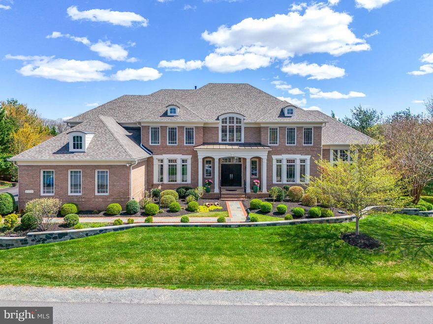 EXQUISITE LUXURY ESTATE IN RED CEDAR WEST -- Discover refined elegance in this meticulously updated Gulick Homes Winthrop model nestled on 1.12 fully irrigated private acres in prestigious Red Cedar West. This stunning residence offers nearly 8,000 square feet of luxurious living space, completely renovated throughout 2023-2024 with over $300,000 in premium upgrades. DISTINCTIVE FEATURES: 7,973 SF of total finished living space (5,400 SF above grade, 2,573 SF finished basement; 5 bedrooms, 5 full bathrooms across three thoughtfully designed levels; Gourmet chef's kitchen featuring SubZero refrigerator, Wolf range, custom Amish cabinetry; Two-story foyer with striking curved staircase setting an impressive tone upon entry; Home office with ensuite bath offering flexibility as a main-level bedroom suite; Full theater room with premium seating (conveys with home); Built-in wine cellar for the discerning collector; Four-zone HVAC system for optimal comfort throughout; Professional-grade outdoor kitchen with pizza oven and fireplace; 856 SF elevated deck overlooking the private, tree-lined property; Professional landscaping with stone wall and built-in landscape lighting; Spacious 3-car garage with ample storage options; Room for additional 2-car garage and in-ground pool. RECENT LUXURY UPGRADES (2022-2024): New roof installation (2023); Complete reconstruction and painting of all windows; Exterior facade enhancement with professional landscaping; Full renovation of master bathroom and two additional bathrooms; Gourmet kitchen redesign with premium appliances and finishes; Refinished hardwood flooring throughout all levels; Fresh interior paint throughout entire home; New HVAC systems (main and upper levels); New water heater installation (2024); Updated window treatments throughout. MAIN LEVEL: Grand two-story foyer with curved staircase, dedicated office/optional bedroom with ensuite bath, formal dining room, conservatory, chef's kitchen open to spacious family room, and sun-drenched sunroom overlooking the private backyard. UPPER LEVEL: Luxurious owner's suite with completely renovated spa bathroom, three additional bedrooms, and two newly updated full bathrooms. LOWER LEVEL: Resort-style entertainment space featuring full wet bar, recreation area, family room, professional theater, exercise room, wine cellar, additional bedroom and full bathroom, plus walkout access to the backyard oasis. Includes 673 SF of unfinished storage space. OUTDOOR LIVING: Over 1,500 SF of finished outdoor space. Entertain in style on the expansive 856 SF deck or gather around the outdoor kitchen and fireplace on the newly extended patio. The 1.12-acre property features mature trees creating a natural privacy barrier while maintaining an open, manicured lawn perfect for outdoor enjoyment. LOCATION: Situated in the prestigious Red Cedar West neighborhood in Leesburg, this home offers privacy and tranquility while remaining convenient to the area's finest shopping, dining, and major commuter routes. This meticulously maintained and updated luxury estate represents an exceptional opportunity to acquire one of Leesburg's premier residences.