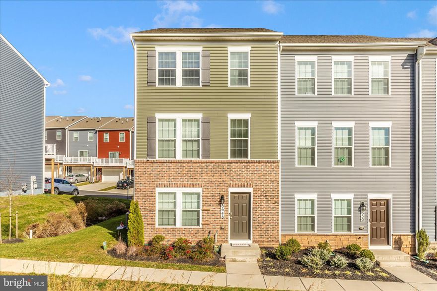 Built only 2 years ago, this spacious end unit townhouse offers 4 bedrooms, 3.5 bathrooms, and a 2-car garage. Fresh Paint throughout the entire house. On the entry level, you’ll find a entry level bedroom with attached full bathroom. Soaring 9-foot ceilings on the main level create an airy, open-concept design. The heart of the home is the oversized kitchen island, ideal for entertaining and gathering. The kitchen is beautifully appointed with beautiful cabinetry, granite countertops, and stainless-steel appliances including a range, side-by-side refrigerator, microwave, and dishwasher. Easy-to-maintain luxury plank flooring flows throughout the main living areas, foyer, and all bathrooms. Upstairs, the primary suite features a generously sized closet, while two additional bedrooms share a stylish hall bath. A convenient upper-level laundry adds ease to everyday living.  All bathrooms feature granite countertops for a cohesive, modern look. Community amenities include a tot lot and scenic walking paths with beautiful mountain views. Plus, with easy access to major commuting routes, you’ll enjoy the perfect blend of suburban comfort and city convenience. Nearby, Frederick offers a vibrant mix of outdoor activities, shopping, dining, and entertainment. Brand new school coming to the area very soon. Schedule your showings now and bring your offers!