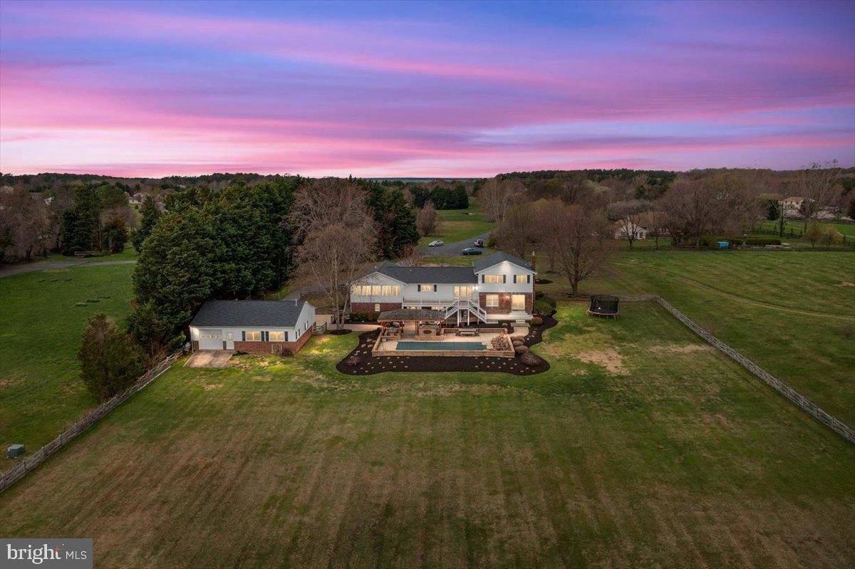 Welcome to 92 Long Creek Drive located on gorgeous Kent Island. This waterfront is everything you have dreamed of! 5 bedrooms, 4 full baths, 3 car attached garage, 3 car detached garage, in ground pool, outdoor kitchen, and pier. Situated on over 2.5 acres, this home offers all the peace and privacy you want. As you walk up to this home, you will notice the mature landscaping all around, long driveway, and the relaxing front porch. As you enter the home, you are instantly hit with gorgeous water views. Boasting 4 levels and OVER 4500 sq ft of finished living space that has been freshly painted, this home is ready for you to start your waterfront lifestyle. On the main level, and to the right as you walk in, you have a large living room offering a ton of natural light. Off of the living room is your private home office. The main level also boasts the gorgeous, renovated kitchen. This kitchen is breathtaking. Gorgeous white cabinets with all new hardware, shiplapped wall, granite counter tops, new commercial grade refrigerator, large custom pantry, eat in table space, and stunning waterfront views!!! You will never want to leave this space! Off of the kitchen and finishing off the main level is the half bathroom, recently added mudroom, home gym and entry to the 2 car attached garage! Moving to the upper level you have 3 bedrooms and 2 full bathrooms. Bedrooms 2 and 3 are large and offer a ton of natural light. Bedroom 2 has been converted into the owner's walk in closet!!! It is MASSIVE!!! Don't need a massive closet? No problem, it's ready to serve as a true bedroom. The hallway full bathroom offers granite counters, tile floors, and plenty of storage space. The views from the owner's suite will take your breath away. Nothing but water views all around, including the owner's suite bathroom with tiled stand up shower, soaking tub, and tile floors. Relax in here and take in all the views!! Moving down to level 3, you have 2 bedrooms, 1 full bathroom, and the living room with fireplace. The bedrooms also offer an abundance of natural light. The living room is large and open with the brick fireplace that has been freshly painted. Moving down to level 4, this is where the fun begins! Full bar, living space, closet space and a full bathroom for your guests to use when coming in from the pool or the water! Also on this level, the entrance to the attached 3rd car garage!!! Moving outback. This is an oasis. The backyard offers a brand new deck off of the kitchen, new concrete patio off of the living room, in ground pool, an outdoor kitchen and pavilion. As if that wasn't enough, you get to take your walk down to the pier with boat lift and all new electric! This home offers deep water and about 250 feet of water frontage. Spend your nights out here fishing and crabbing and just soaking in this waterfront lifestyle to its fullest. Moving back towards the house, you have your detached 3 car garage with heat. This is the perfect spot for all your toys, lawn equipment, fishing rods, crab pots OR park all your vehicles in here! So many options here! This home is the exact lifestyle you have been waiting for. Soak up the days by the pool or on the pier. Hop on your boat, jet skis or kayak anytime you want and head out and explore! This home offers so many possibilities that you will never have a dull moment. Come see what this lifestyle is all about!!!