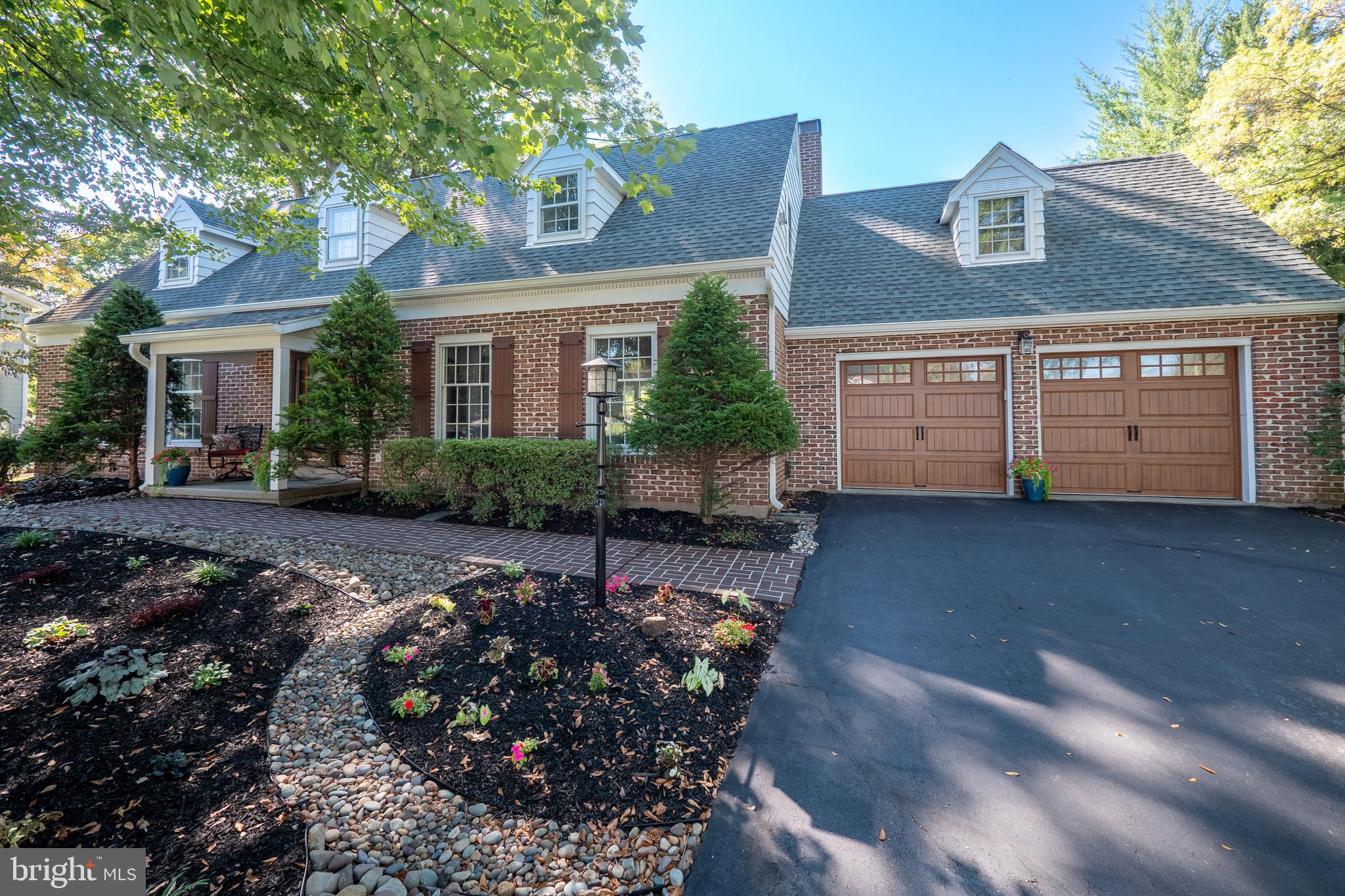 This stunning expanded all-brick Cape Cod blends timeless craftsmanship with thoughtful modern updates, offering both elegance and comfort in an enviable Bethlehem location. Perfectly situated just minutes from downtown, fine dining, shops, and major routes, this home combines convenience with a quiet, residential setting. From the moment you arrive, the curb appeal is undeniable, with its classic brick façade, new front entry with sidelights, updated shutters, and new garage doors creating a lasting first impression. Step inside to a beautifully appointed interior where gleaming hardwood floors flow seamlessly across both the main and upper levels. The living room sets a refined tone with crown molding, wall details, large windows, and recessed lighting, while the formal dining room provides an inviting backdrop for holiday gatherings or intimate dinner parties. At the heart of the home, the exceptional kitchen has been designed for both function and style. A generous quartz peninsula with seating invites conversation, while stainless steel appliances, wall oven, flat top range, and a striking tile backsplash elevate the space. Open sightlines lead to the sunlit breakfast nook and the warm, inviting family room. Here, a wood-burning fireplace framed in brick with a classic mantel and custom built-ins anchors the room, creating the perfect gathering place. A spacious first-floor laundry room and a stylish new half bath complete this level. Upstairs, the serene primary suite is a true retreat, featuring hardwood floors, charming dormer windows, dual closets—including a walk-in—and a beautifully updated ensuite with dual vanity and luxurious walk-in shower. Three additional bedrooms, each with generous closet space, and a second full bath complete the upper level. Modern enhancements include Lutron smart recessed lighting, ensuring comfort and efficiency throughout. Outdoors, a covered porch opens to a slate patio overlooking the expanded and professionally landscaped yard—a private oasis ideal for entertaining or quiet relaxation. This home embodies the rare balance of character, convenience, and thoughtful updates. A truly exceptional opportunity—schedule your private showing and experience all that this Bethlehem residence has to offer.