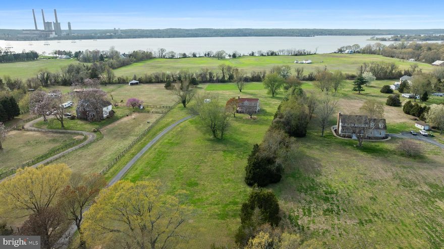 Welcome to a place where time slows down, the air feels a little fresher, and the possibilities stretch as far as the eye can see…

Nestled on nearly 6 acres of open, level land in the heart of Calvert County, this one-owner home has been lovingly cared for since it was built in 1993—and it shows in every detail. From the moment you arrive, the classic farmhouse-style wraparound porch invites you to sit back, unwind, and take in the peaceful surroundings.

Step inside and you’ll find a warm, inviting interior anchored by a cozy woodstove insert—perfect for those crisp Maryland evenings. The kitchen and dining area flow seamlessly together, creating a natural gathering space that opens directly to a screened and covered rear deck. Here, you’ll enjoy serene views of the expansive backyard and glimpses of the Patuxent River—a setting that feels both private and inspiring.

The full, unfinished basement offers a blank canvas ready to become whatever you envision—additional living space, a workshop, home gym, or storage for all your hobbies and equipment. Outside, the possibilities truly shine. With nearly 6 acres of usable land, this property is ideal for horses, chickens, hobby farming, gardens, or simply enjoying wide-open space with room to breathe.

An asphalt driveway provides easy access, and with NO HOA, you have the freedom to create the lifestyle you’ve been dreaming about—without restrictions.

Perfectly positioned to offer both tranquility and convenience, this home captures the essence of Southern Maryland living. Whether you're seeking a peaceful retreat, a homestead, or a place to bring your creative vision to life, this property is more than just a home—it’s an opportunity.

Come experience the charm, the space, and the lifestyle that make Calvert County so special.