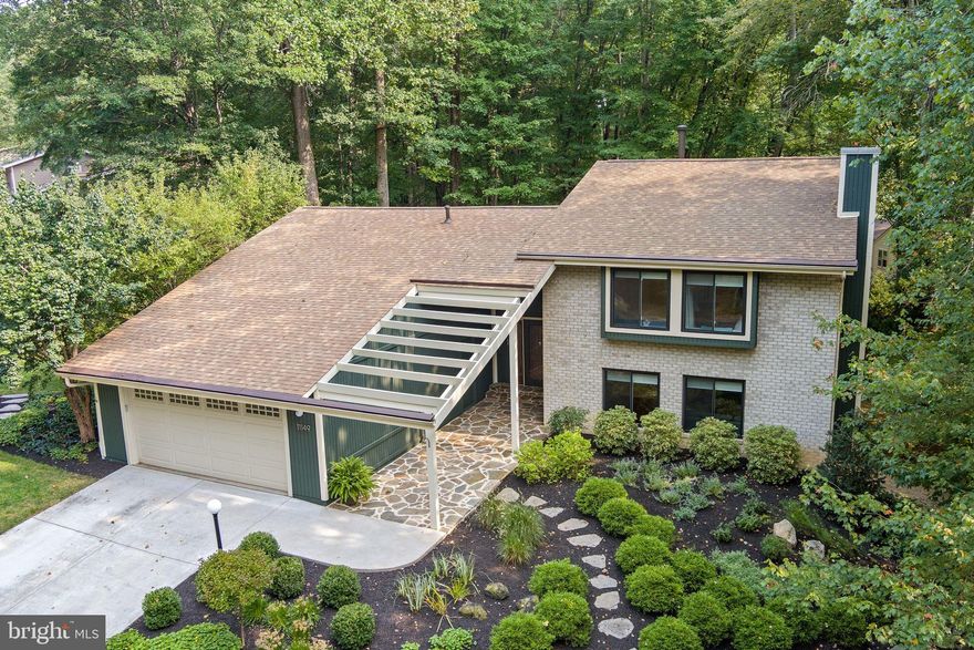 Step into this stunning mid-century modern gem tucked away in the heart of Columbia’s desirable Hobbits Glen neighborhood in the Village of Harper’s Choice.. With 5 bedrooms, 3 full baths, and thoughtful design throughout, this turn-key ready home is the perfect blend of form, function, and natural beauty.

Inside, the semi-open layout offers a seamless flows while still preserving designated living and dining areas—perfect for entertaining or simply enjoying the serenity of your space. Throughout the home, hardwood floors, vaulted ceilings, and contemporary lighting fixtures elevate every room.

The kitchen has been thoughtfully designed to reflect the home's mid-century modern roots. It features an eat-in layout with a vaulted ceiling accented by exposed wooden beams, adding warmth and architectural character. Contemporary tile backsplash and sleek stainless steel appliances offer a modern touch. Natural light pours in, enhancing the space’s airy feel, and the kitchen opens to the wrap-around deck which connects to the screened porch accessed off the dining room, allowing for seamless indoor-outdoor living that extends to a backyard.

The lower-level living area stuns with its gorgeous stone feature wall and gas fireplace, and large windows that invite in abundant natural light and frame the lush green views. Not to be outdone, a second living area boasts its own architectural charm with a vaulted ceiling and even more expansive windows overlooking mature trees.

With five well-sized bedrooms, this home offers flexibility for families, guests, home offices, or creative spaces. The three full bathrooms are thoughtfully designed to complement the home’s timeless style and function.

Tucked away in a peaceful setting yet just minutes from major routes, shopping, dining and parks, this home offers the rare combination of retreat and convenience.