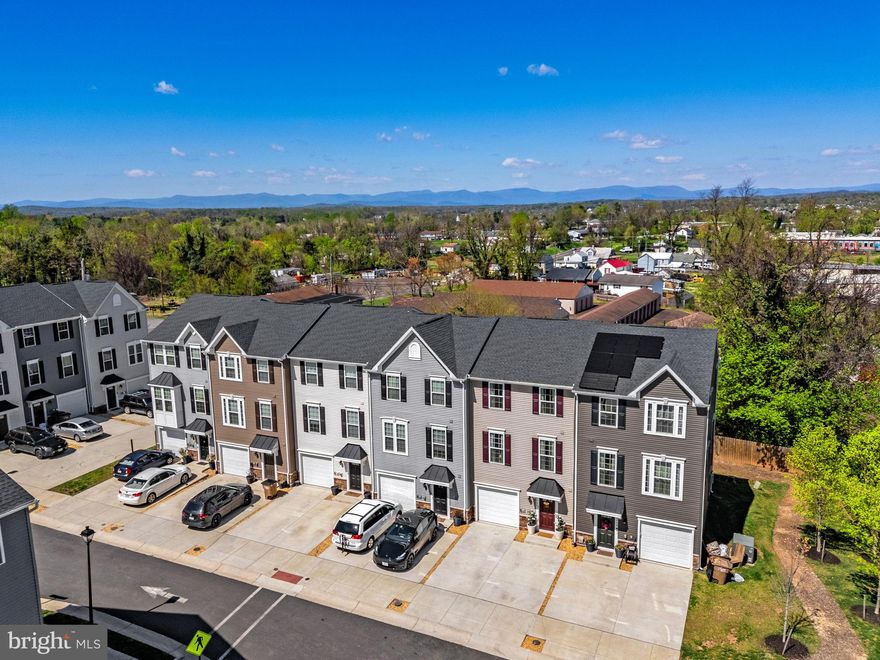 Welcome to 1756 Scenic Loop, a beautifully upgraded, like-new townhome in Culpeper's Madison Station. The lower level of the home features LVP flooring throughout, a half bath, a bright rec or flex space, and access to the attached one-car garage.  The main level offers an open and inviting layout with LVP flooring throughout, a spacious living room with an electric fireplace, and a stylish eat-in kitchen, featuring a large island, quartz countertops, and stainless steel appliances. Just off the kitchen, step onto the Trex deck and take in seasonal mountain views.  Upstairs, the owner’s suite includes mountain views, a tray ceiling, walk-in closet, and an upgraded en suite bath with a double vanity and shower bench. Two additional spacious bedrooms, a full bathroom, and a convenient laundry closet complete the upper level. Madison Station residents enjoy access to a community pavilion and a prime location less than a mile from historic downtown Culpeper, with quick access to Route 29 for commuters. This is a fantastic opportunity to own a nearly new home in a highly convenient location.