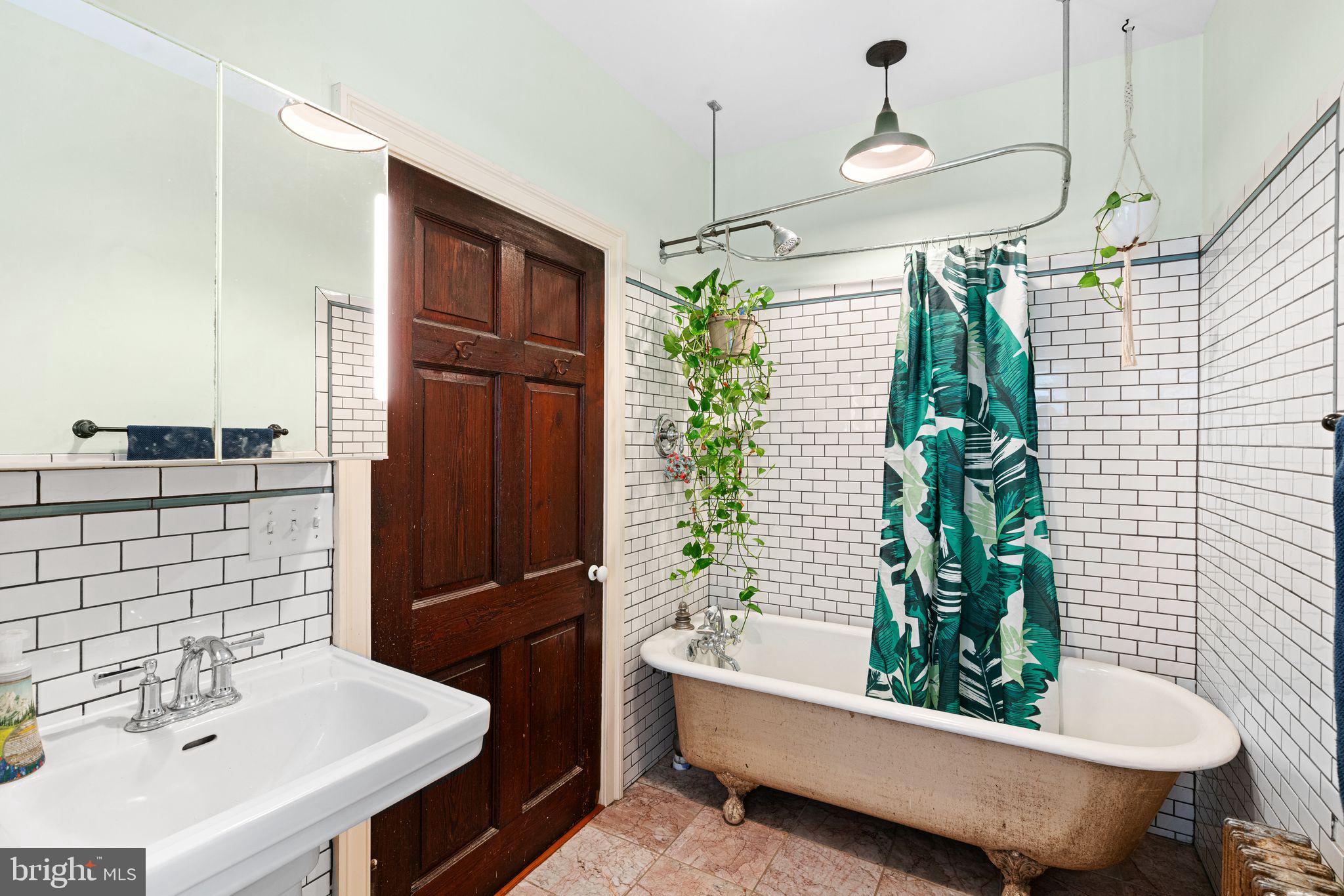 Welcome to 1241 N. Hollywood Street — where timeless charm meets modern convenience on one of Brewerytown’s most picturesque blocks. Nestled on a quiet, tree-lined street with friendly neighbors and a strong community vibe, this thoughtfully renovated 2-bedroom, 1.5-bath home offers just under 1,000 square feet of curated living space and city living at its finest. Step inside and be greeted by a bright, open floor plan and freshly refinished real hardwood floors that flow throughout the home. The home is framed by deep-silled windows throughout that pour in natural light, while salvaged doors, repointed brick, and enamel light fixtures preserve the home’s original character. The stylish kitchen features quartz countertops, stainless steel appliances, and a classic subway tile backsplash. The first floor also offers a convenient half bath—perfect for entertaining. From the kitchen, step out to your private rear patio, paved with reclaimed brick from a historic church, accompanied by a blooming garden and handy storage for your gardening tools. A shared but portioned-off side patio provides an elevated, peaceful space—ideal for a reading nook, potted plants, or morning coffee. Upstairs, the oversized full bathroom feels like a retreat with natural stone floors, a 6-foot clawfoot tub, subway tile, a Toto sink, and built-in cabinetry. Two well-sized bedrooms offer large closets, while updated Andersen windows throughout the home provide energy efficiency and abundant natural light. Downstairs, enjoy a freshly painted and sealed basement offering tons of storage and a high-end Bosch washer and Miele dryer. Additional upgrades include updated electrical and plumbing, new siding on the back wall, and a custom, locally hand-painted gold leaf address by a Fairmount artist—a one-of-a-kind finishing touch. Situated in the heart of Brewerytown with a Walk Score of 83 and a Bike Score of 84, this location is a commuter’s dream. Enjoy easy access to SEPTA’s 48, 49, and Route 15 trolley, and walk to local cafes, restaurants, parks, and cultural hotspots. Whether you’re biking to Boathouse Row or grabbing groceries nearby with a quick walk to Aldi, this home connects you to everything that makes Philadelphia the most walkable city in America. Don't miss your chance to own a piece of history with all the comforts of today—1241 N. Hollywood Street is ready to welcome you home. This property is located in a geographic area which may result in the buyer being eligible for special loan programs which may provide additional financial assistance to buyers.