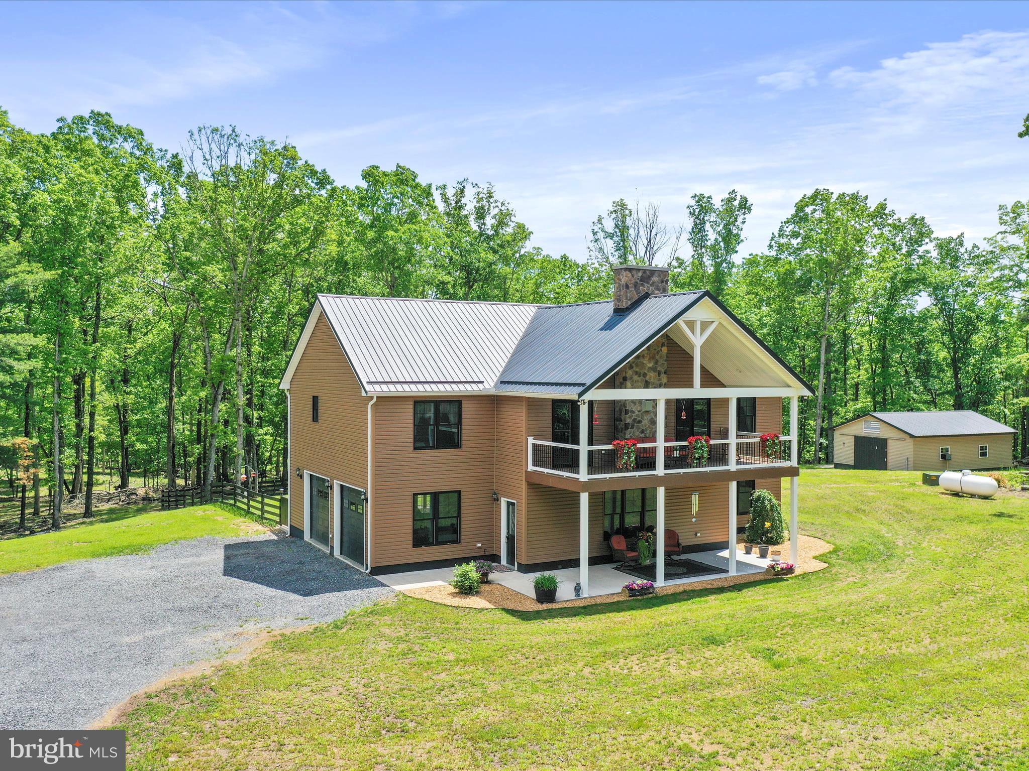 The Perfect Blend of Privacy and Convenience — Welcome Home!
Nestled between Moorefield and Wardensville, this beautiful property offers the best of both worlds: peaceful mountain living with quick access to Route 48, making trips to the D.C. Metro area a breeze. perfectly situated on over 8 mostly level, wooded acres - this home offers privacy, space, and comfort in an ideal location.
Thoughtfully designed and impeccably maintained, the home exudes warmth and elegance from the moment you arrive. Enjoy outdoor living on two expansive 26' x 12' Trex decks—one in the front and one in the back—perfect for morning coffee, evening wildlife watching, or entertaining. Concrete patios beneath each deck offer additional space for seating or future enhancements.
Inside, the upper level welcomes you with a spacious family room centered around a stunning stone gas fireplace—perfect for cozy evenings. The kitchen is a true showstopper with rich hickory cabinetry, granite countertops, a breakfast bar with stone detailing, and a separate coffee bar. Just off the kitchen, a large walk-in pantry provides ample storage for food and appliances.
The front-facing primary suite offers a peaceful retreat and a luxurious en-suite bath featuring an oversized, beautifully tiled shower and generous cabinetry. Another bedroom and a full bath complete the upper level.
The lower level offers a comfortable second family room, a flexible third bedroom currently used as a home office or study, a half bath, and a combined laundry and utility room. You'll also appreciate the attached garage with convenient interior access and a rear door leading to the partially fenced backyard. For even more storage or workshop potential, a 24' x 32' detached garage with electricity and a concrete floor adds exceptional value and versatility to the property.
This move-in-ready home combines modern comfort with scenic surroundings—don’t miss your chance to own a piece of West Virginia paradise.