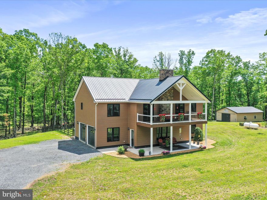 The Perfect Blend of Privacy and Convenience — Welcome Home!

Nestled between Moorefield and Wardensville, this beautiful property offers the best of both worlds: peaceful mountain living with quick access to Route 48, making trips to the D.C. Metro area a breeze. perfectly situated on over 8 mostly level, wooded acres - this home offers privacy, space, and comfort in an ideal location.

Thoughtfully designed and impeccably maintained, the home exudes warmth and elegance from the moment you arrive. Enjoy outdoor living on two expansive 26' x 12' Trex decks—one in the front and one in the back—perfect for morning coffee, evening wildlife watching, or entertaining. Concrete patios beneath each deck offer additional space for seating or future enhancements.

Inside, the upper level welcomes you with a spacious family room centered around a stunning stone gas fireplace—perfect for cozy evenings. The kitchen is a true showstopper with rich hickory cabinetry, granite countertops, a breakfast bar with stone detailing, and a separate coffee bar. Just off the kitchen, a large walk-in pantry provides ample storage for food and appliances.

The front-facing primary suite offers a peaceful retreat and a luxurious en-suite bath featuring an oversized, beautifully tiled shower and generous cabinetry. Another bedroom and a full bath complete the upper level.

The lower level offers a comfortable second family room, a flexible third bedroom currently used as a home office or study, a half bath, and a combined laundry and utility room. You'll also appreciate the attached garage with convenient interior access and a rear door leading to the partially fenced backyard. For even more storage or workshop potential, a 24' x 32' detached garage with electricity and a concrete floor adds exceptional value and versatility to the property.

This move-in-ready home combines modern comfort with scenic surroundings—don’t miss your chance to own a piece of West Virginia paradise.