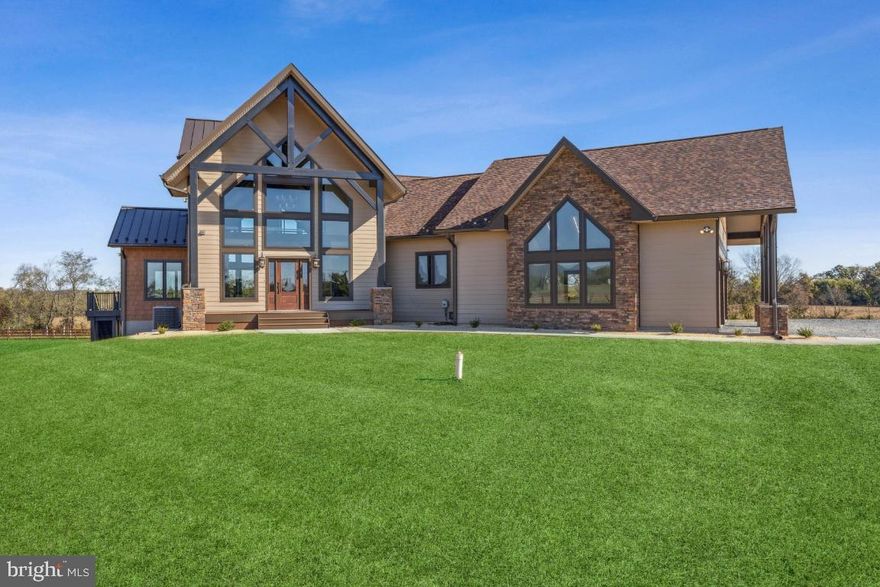 Welcome to the Pointer's Lodge, a one-of-a-kind custom-built home situated with views of the Catoctin mountains and architectural details that are sure to impress for years to come. This home is situated on 25 beautiful acres. The exterior is built with heavy timber trusses, ledge stone, cedar rough split shakes, and Hardie plank lap siding in modern earth-based tones. Guests are welcomed by a large two-story front porch with floor to ceiling windows, blending the outdoors and indoors in true lodge-home form. With almost five thousand finished square feet, this three bedroom, three and a half bath home boasts not only a gorgeous exterior but thoughtfully designed floors plank and interior details key to a mountain home. The first level features the kitchen at the heart of the home, with a family room extending to the rear. Here, cathedral ceilings and a large fireplace create an intimate gathering place with floor to ceiling windows offering views to the north. The master suite and dining room both connect to the sprawling rear deck, making outdoor living part of the home's form and function. The upstairs loft, combined with the finished basement, provides ample space for gathering and hosting. Planned design details include interior stone and cedar accents, strong craftsman rails, wood tones throughout to truly encompass the spirit of a lodge home, with modern touches such as glass rails and dark hardware accents. This home was custom designed and custom built for the descerning owners.