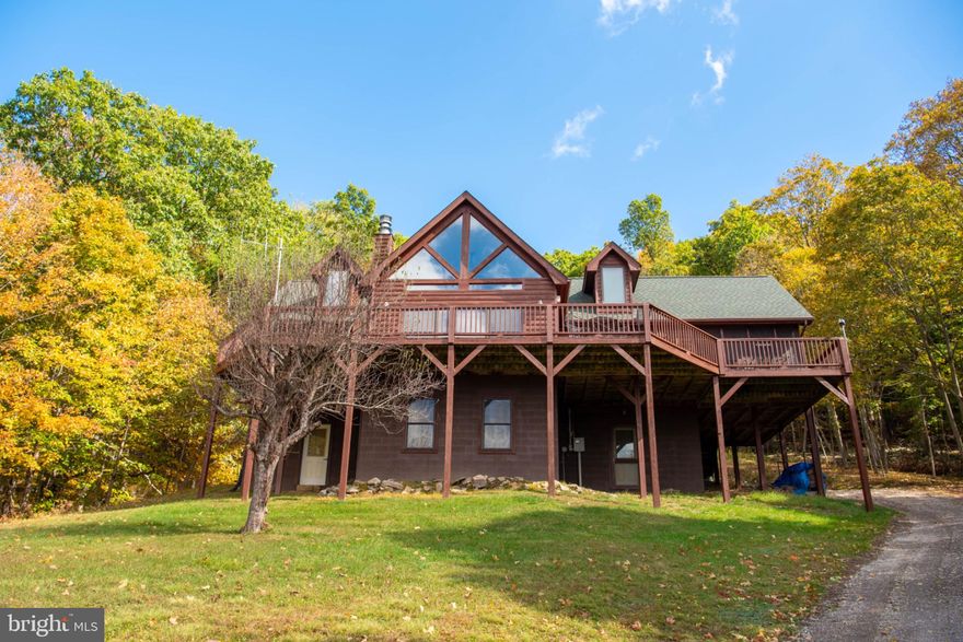 Lost River cabin with 3 bedrooms and 3.5 bathrooms  on 26 acres bordering George Washington National Forest.  Escape to this private mountain retreat set on a remarkable 26 acres (3 separate lots) with a direct border to the George Washington National Forest. This is the perfect sanctuary for outdoor lovers seeking quiet and direct access to thousands of acres of wilderness for hiking, hunting, and exploration. With a large and bright great room as well as a  lower level family room and bonus room the cabin offers comfortable accommodations for family and friends. A welcoming wrap-around deck and a cozy screened porch are ideal for enjoying the mountain air and scenery. 
Located in the serene Lost River Valley, this property is the perfect spot to unplug and enjoy the simple, natural beauty of West Virginia.
Come see your mountain getaway today!