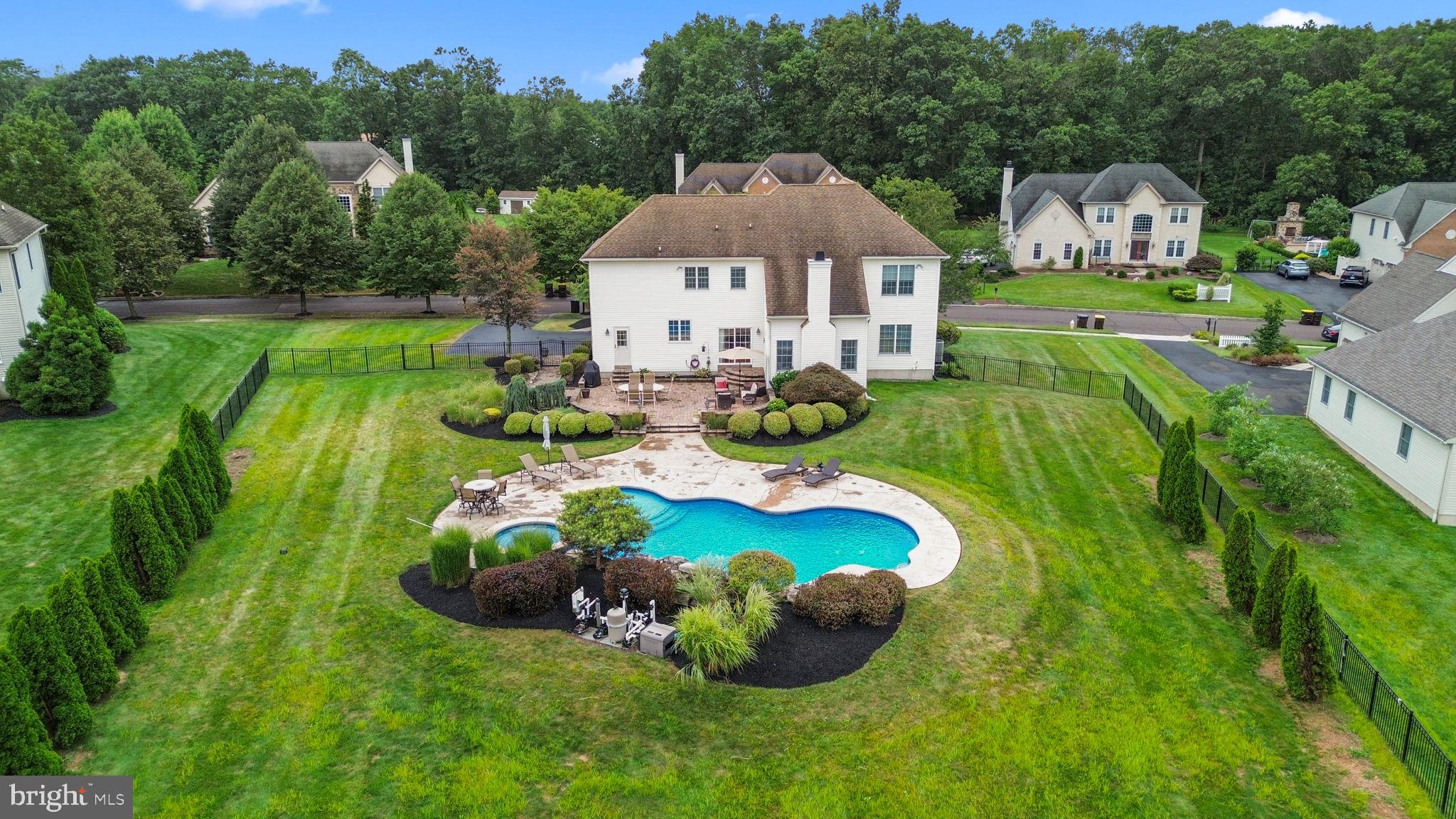 Welcome to this spacious home in the desirable Hilltown Chase community within the Pennridge School District. Offering over 3,500 square feet, 4 bedrooms, and 3 bathrooms, this residence blends style, comfort, and function. Step inside the two-story foyer with hardwood floors and notice the open floor plan and vaulted ceilings that fill the main living spaces with natural light. The gourmet kitchen flows into the family room with a fireplace & vaulted ceiling, creating an ideal space for both daily living and entertaining. A formal dining room adds an elegant touch for gatherings, while a private study with custom wood built-ins offers a quiet retreat. The finished basement expands your living space with a bar, built-in shelving, and room for recreation whether it’s enjoying a game of pool or hosting friends. Upstairs, the primary suite includes a spa-like bathroom and two walk-in closets, providing a comfortable escape at the end of the day. Outdoors, the backyard is the true highlight. The heated pool features a remote-controlled waterfall, surrounded by a landscaped (And fully fenced-in) yard and patio for lounging or entertaining. This private retreat was designed for year-round enjoyment. Additional conveniences include a two-car garage, a whole-home security system, and thoughtful details like wood built-ins throughout. Located just minutes from downtown Perkasie, residents can enjoy nearby parks, shops, breweries, and community amenities including Castillo's, Sapori & Maize. This Hilltown Chase home combines size, style, and location in one exceptional package. Schedule your showing today to experience everything it has to offer.