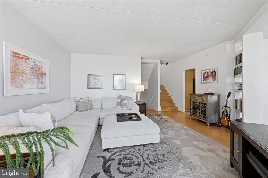 Renovated and chic corner unit tri level one-bedroom, one-and-a-half-bath at Rivers Edge Condominiums in Logan Square — one of the most underrated buildings in Center City. This corner unit delivers three levels of sun-filled living space with hardwood floors throughout, a spacious kitchen with stainless steel appliances and granite counters, a dining area with built-in bookshelves and banks of windows facing the river, and a living room that opens through sliding glass doors to a west-facing balcony with Schuylkill River views — the kind of spot where you decompress after a long day and feel like you left work behind. The bedroom level has an en-suite renovated bath, a custom closet, and a dedicated desk nook — a rare and truly spacious bedroom suite with enough room to work from home without your office living on your nightstand. Both bathrooms have been fully renovated. The in-unit laundry room includes a tankless on-demand water heater, so you're never waiting on hot water and never paying to heat a tank you're not using. One assigned indoor parking spot is included — big enough to fit a truck, but honestly you might forget you own a car. Your front door puts you directly on the Schuylkill River Trail — 30+ miles of running and biking paths from Fairmount Park to the South Philly waterfront. Lace up, walk outside, and you're already on the trail. No driving to a gym, no treadmill, no excuses. The building offers 24/7 concierge and doorman service, a panoramic rooftop sundeck with skyline views, and a secure on-site garage. Rivers Edge has undergone major capital improvements in recent years including new Italian windows, a new boiler system, restored facade, and a rebuilt rooftop deck. Location is where this unit really separates itself. 30th Street Station is minutes away — Amtrak, SEPTA Regional Rail, the subway, all of it. If you work at Penn or Drexel, you're across the bridge and at your desk in under ten minutes. Center City commuters can walk, bike, or hop on transit without thinking twice. Giant is literally next door for groceries, Trader Joe's is a short walk, and the Philadelphia Museum of Art and the entire Benjamin Franklin Parkway cultural corridor are all walkable. Easy access to I-76, I-676, and Amtrak when you need to get out of the city. This is a move-in ready condo for someone who wants to live where they can walk to work, run along the river, and come home to a sunset view — without giving up a doorman, a parking spot, or a real bedroom. That combination doesn't come up often at this price point. Seller will PAY the full assessment!