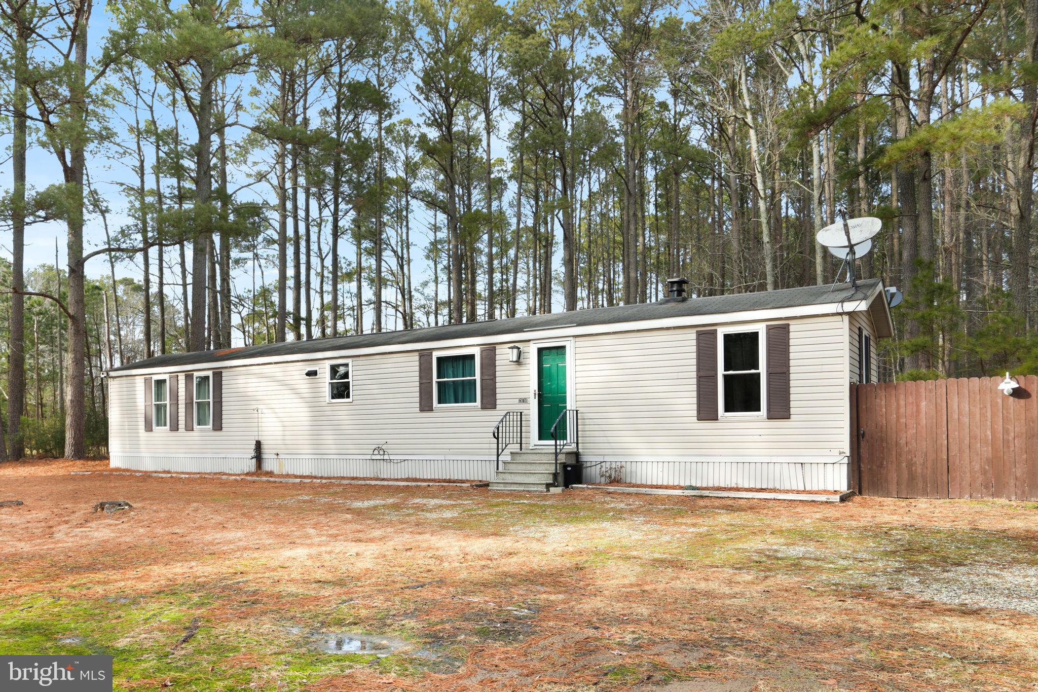 Nestled on a private wooded lot in Marion Station, this delightful 2-bedroom, 2-bathroom manufactured home is a paradise for nature lovers. Offering a serene retreat, it combines modern comforts with a lush, tranquil setting. The spacious living room greets you with stylish LVP flooring, providing a warm and inviting atmosphere for relaxation or entertaining. The eat-in kitchen is the heart of this home, featuring a functional breakfast bar, stainless steel appliances, and a built-in pantry closet for all your culinary needs. The primary bedroom is a sanctuary in itself, complete with a private bathroom for added convenience and privacy. An additional bedroom and another full bathroom ensure plenty of space for guests or a growing family. Functionality is enhanced with a dedicated laundry room, simplifying daily routines. Step outside onto the rear deck, perfect for enjoying the peaceful surroundings or hosting outdoor gatherings. A large shed provides ample storage space for tools and outdoor equipment. Embrace the charm of nature and comfort in one beautiful package.