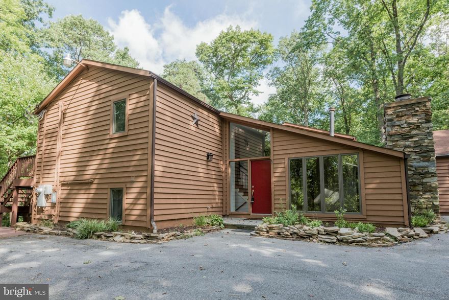 Very private, Scenic Views, 1 Acre wooded lot, 3 Bedrooms, Large open kitchen w/granite top island w/lots of windows w/breathtaking views, LL den could be used as 4TH BR, 2 Full Baths, Large Master Suite. Fireplace in Family Room, Formal dining room, 2-Level deck that wraps around house, Large 2-Car Garage, Walk to Patapsco State Park.