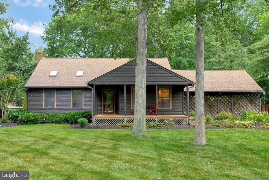 So much more than meets the eye!!  Nestled among mature trees on a one and one-third acre lot, with beautiful and meticulously manicured landscaping, this charming cedar sided split level home is an absolute gardener’s delight!  It’s also perfect for a car enthusiast/mechanic with a detached three-bay garage.  Large covered front porch, entering the home you’ll find a living room with stained wood accent wall and ceiling with skylights offering an abundance of natural light.  The kitchen has been remodeled and features Corian countertops, breakfast bar, tiled backsplash, and large walk-in pantry, along with an adjacent spacious dining room.  The upper level foyer is open to the main level living room, and the owner’s suite boasts atrium doors with interior blinds leading to your own private balcony overlooking the extensive flower gardens and landscape! The en-suite remodeled bath is complimented with a custom tiled shower with niches, frameless shower doors and rain shower head fixture.  There’s also two additional sizeable bedrooms and a remodeled hall bath with tub/shower combo.   A pellet stove with brick surround keeps the lower level recreation room warm and cozy on winter nights, with sliding glass door access to your outdoor personal refuge with custom patio, pergola and extensive gardens lined with river rocks.  An updated half bath, laundry area/mud room, and additional flexible and versatile finished space ideally situated for an in-home office complete the lower level, with access to the two-car carport, with epoxy painted floor. Beyond the backyard landscape, situated well away from the home is the heated three bay garage featuring an oil pit, restroom, small office, and machine shed, along with additional outdoor work space.  Easy access to Rt 2, 10 and 97, along with the Earleigh Heights Shopping Plaza and Lake Waterford Park!