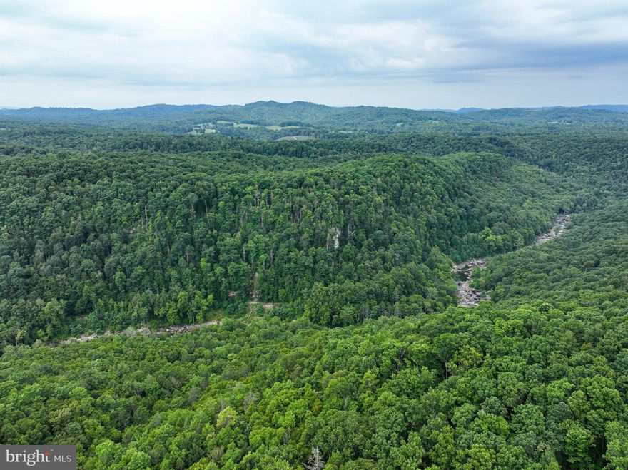 Nestled in the heart of West Virginia's most sought-after outdoor recreation area, this exceptional property offers a true paradise for adventure sports and hunting enthusiasts. Located along the pristine Meadow River, just a short distance from Summersville Lake and the iconic New River Gorge, this property boasts some of the best rock-climbing terrain in the state.

With approximately a half mile of frontage on the tranquil Meadow River, you'll be captivated by the stunning panoramic views of the surrounding mountains and the river's gentle flow. The property is a haven for wildlife, offering abundant opportunities for hunting, birdwatching, and simply immersing yourself in nature.

For those seeking adventure, the location is unbeatable. You're just minutes away from world-renowned climbing destinations, including the New River Gorge, known for its challenging routes and breathtaking scenery. In addition, the vibrant town of Fayetteville, WV—often celebrated as "The Coolest Small Town in America" by multiple publications—is only a short drive away. Here, you'll find a lively community with charming shops, local eateries, and a welcoming atmosphere that perfectly complements the area's rugged beauty.

Despite its secluded and private setting, the property offers modern conveniences, including access to municipal water and electricity. This rare combination of wilderness seclusion and accessibility makes it the perfect spot to build your dream retreat, where you can enjoy the best of both worlds.

Whether you're an avid outdoorsman, a rock-climbing enthusiast, or simply someone seeking a serene escape surrounded by nature's beauty, this property on the Meadow River is your gateway to adventure, tranquility, and the unique charm of Fayetteville.