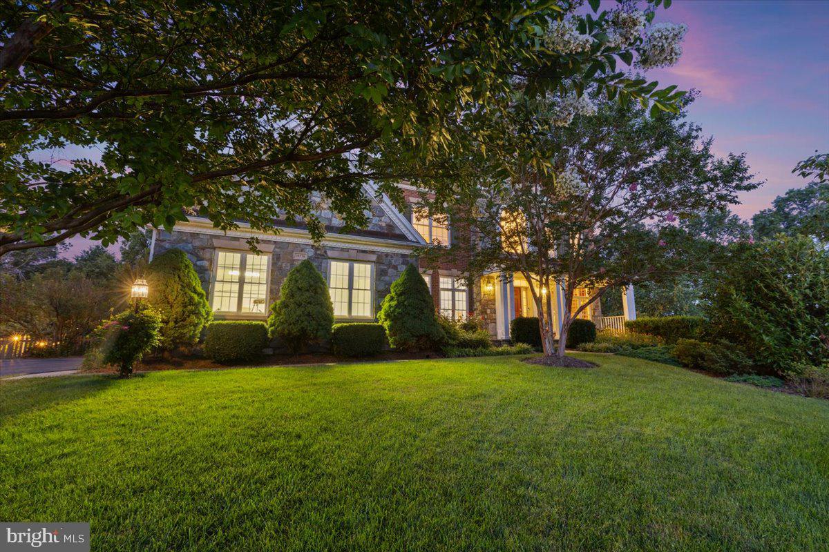 If you are looking for a beautiful home with a lush backyard, this is it! Situated on 0.3 acres at the end of a cul-de-sac, this grand home has everything you need and more. As you pull into the driveway you can't help but notice the extensive landscaping. As you approach the front door, the brick and stone exterior and inviting front porch welcome you home. Upon entry, you're greeted by hardwoods that flow throughout the main level of the home. An expansive, two-story foyer sets the stage for the open feel of this expansive floor plan. The formal living room flows into the formal dining room providing ample space for entertaining, while the large kitchen has storage galore, stainless steel appliances, a gas cooktop, and double oven--making cooking for a crowd a piece of cake. The eat-in area and kitchen island provide plenty of room for additional seating. The focal point of the adjacent two-story family room is the floor to ceiling stone fireplace--a perfect place to spend a cozy evening. Off the kitchen and family room is a low-maintenance composite deck and screened-in porch that overlook a spectacularly landscaped, fully-fenced backyard that backs to trees. The raised beds alongside the fence are a gardener's dream, while the perfectly manicured lawn provides plenty of room for backyard fun. Underneath the deck and screened porch is a stone patio complete with a porch swing, providing more opportunity to enjoy the tranquility of this private sanctuary. Finishing out the main level are a powder room, laundry room, and an office with built-in shelving and french doors that makes working from home a pleasure. Two staircases provide access to the upper level where you'll find 4 bedrooms and 3 full baths. The generously-sized primary bedroom has plenty of space for a king bed, furniture, and a sitting area. The sizable primary bath features separate vanities, a corner soaking tub, oversized shower, and water closet. Across the hall are two secondary bedrooms separated by a Jack-and-Jill bath. On the opposite end of the upper level is another bedroom with its own ensuite bath. The lower level is the perfect spot for hanging out, but would also be a great in-law suite. The enormous rec room provides more than enough space for a pool table, theater area, and more. The kitchenette is convenient for entertaining and perfect for living independently on that level. There's a bonus room that's currently being used as a guest room with an attached full bath and walk-in closet. Two large storage rooms and closets on this level provide a plethora of storage in addition to the many closets throughout the home. This home truly has it all!