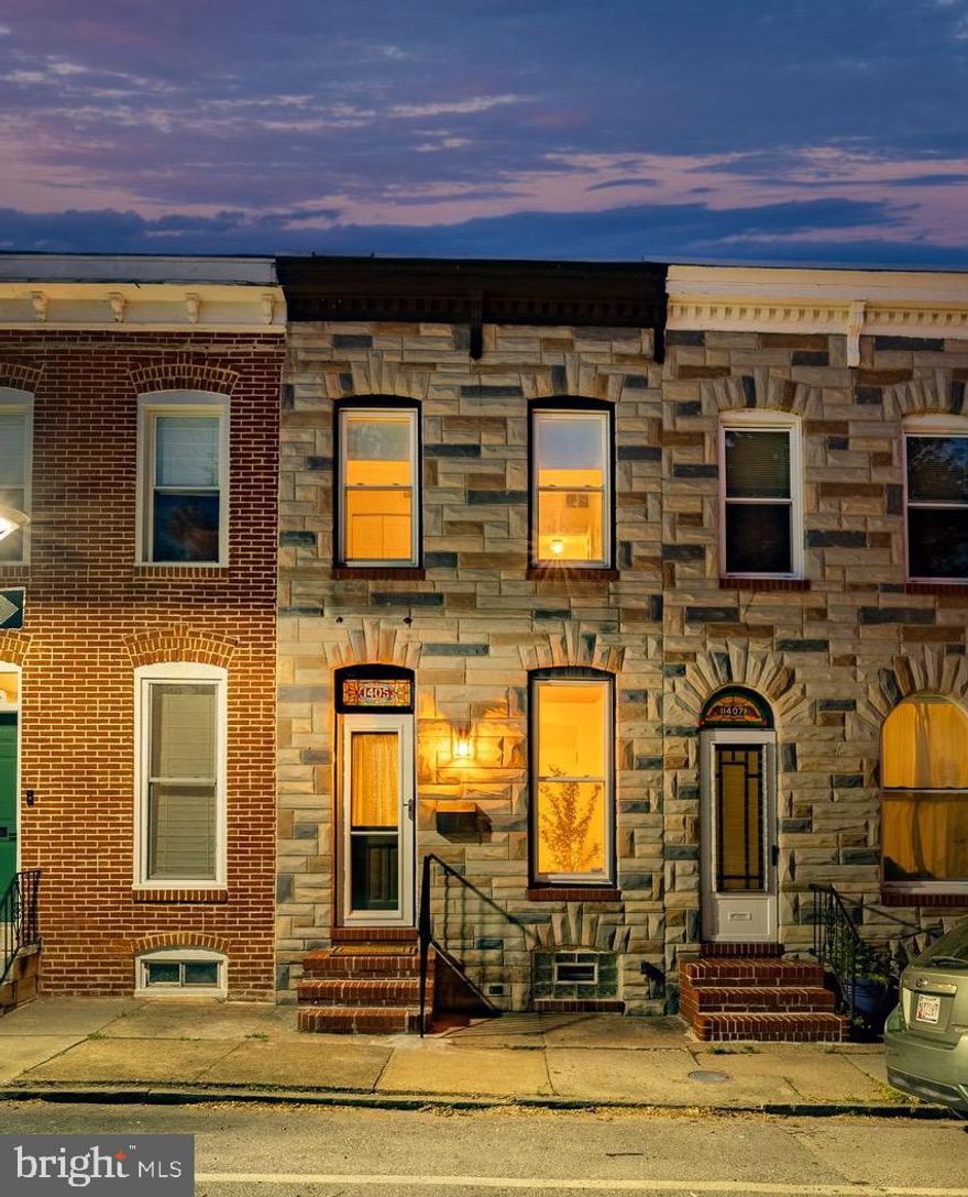 Everything you’re looking for in a home under $300,000 — parking, a rooftop deck with sweeping harbor views, 2 bedrooms, 1 full bath, and a finished basement — all in an incredible Riverside location!
Step inside to find beautiful hardwood floors and exposed brick, a classic Baltimore charm. The sun-filled living room flows into a spacious dining area featuring a custom tray ceiling, statement light fixture, and built-in storage cabinet. The functional galley kitchen offers ample prep and workspace, while the covered rear porch leads directly to a coveted private parking pad. Upstairs, you’ll find two generously sized bedrooms with abundant closet space and a spacious rear bathroom complete with playful custom tile flooring, a soaking tub, and plenty of storage. From this level, access the rooftop deck where you can enjoy panoramic harbor and neighborhood views — the perfect spot to relax or entertain. The partially finished basement adds valuable flexible living space, ideal for a second living area, home office, or gym, along with additional unfinished space for laundry and storage. Immaculately maintained throughout, this home truly showcases pride of ownership.
