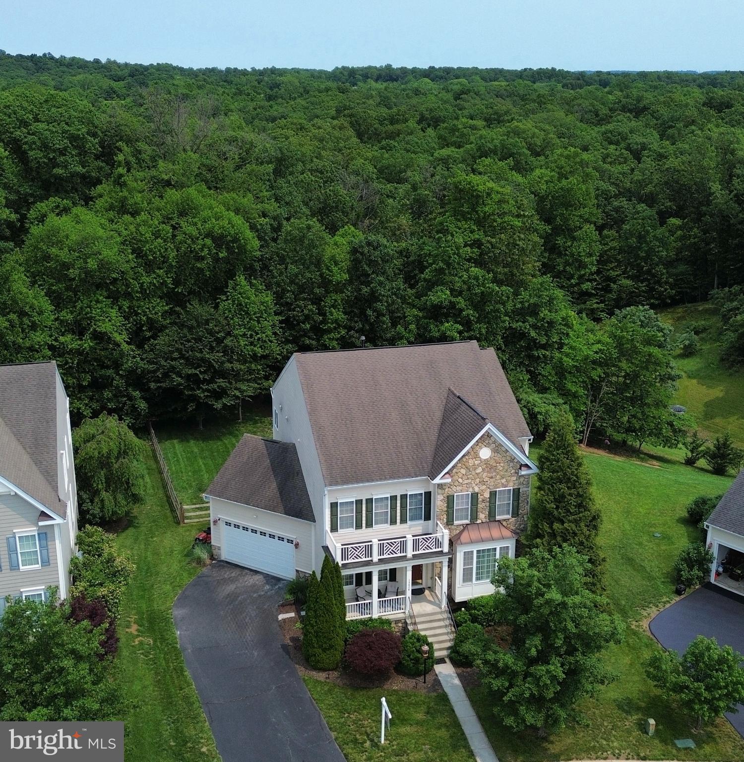 Welcome to Elysian Heights—Where Comfort Meets Community and Nature.
Take in the fresh mountain air and scenic wooded views as you arrive at one of the largest homes in this sought-after neighborhood, ideally sited on a ½-acre lot that backs to trees for ultimate privacy and tranquility. Located in one of Loudoun County’s friendliest communities, you’ll enjoy convenient access to the MARC train for easy commuting to Washington, DC.
With over 5,000 square feet of beautifully finished living space across three levels, this home offers generous proportions and numerous updates throughout. The bright and airy kitchen boasts new quartz countertops, stainless steel appliances, recessed lighting, and ample seating—ideal for both everyday living and entertaining. A sunny breakfast room opens to a screened-in covered porch and adjoining open-air deck, perfect for grilling, relaxing, or soaking up the sun. The family room is anchored by a cozy gas fireplace, while a private main-level study provides the perfect work-from-home retreat.
Upstairs, the spacious primary suite features dual walk-in closets with custom built-ins and a spa-like bath with soaking tub, separate shower, dual vanities, and a private water closet. A separate princess suite includes its own ensuite bath, while two additional bedrooms share a third full bath.
The walk-out lower level is designed for fun and functionality, offering a large rec room with durable LVP flooring, a fifth bedroom, full bath, and two oversized storage rooms.
Outside, the fenced backyard is a private oasis backing to mature trees, with both screened and open-air living spaces ideal for year-round enjoyment. Just a short stroll to the community pool and playground, with tennis and basketball courts nearby for added recreation.
