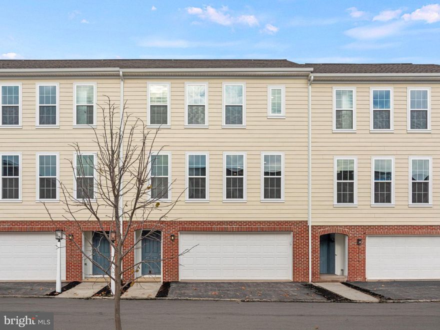 Discover exceptional value and modern design in this move-in ready townhome in the newest phase of Arcona. Thoughtfully crafted for comfortable living, this 2-bedroom, 2.5-bath home offers a bright, open-concept layout with stylish finishes throughout. Classic curb appeal shines with durable Hardie Plank® siding, brick accents, and timeless architectural details. Step through the front door to a welcoming entryway that leads to an oversized 2-car garage with an additional 150 square feet of storage space—perfect for your gear, tools, or seasonal décor. Upstairs, the main living area impresses with a sleek, modern kitchen featuring stained maple cabinetry, a prep island, granite countertops, and stainless-steel appliances. The spacious great room is bathed in natural light, thanks to generous windows that create a warm and airy feel. On the upper level, you’ll find a cozy secondary bedroom and full bath, plus a private primary suite offering a walk-in closet and its own en-suite bath. With both practicality and style, this home is an ideal blend of value, comfort, and low-maintenance living. Situated on the West Shore, Arcona features a neighborhood pool, an artisanal dining restaurant, a Pilates studio, a coffee shop, an ice cream parlor, a pizza shop, a salon, an interior design boutique, a 24-hour fitness center, parks, scenic walking trails, and more all within walking distance from your front door.
