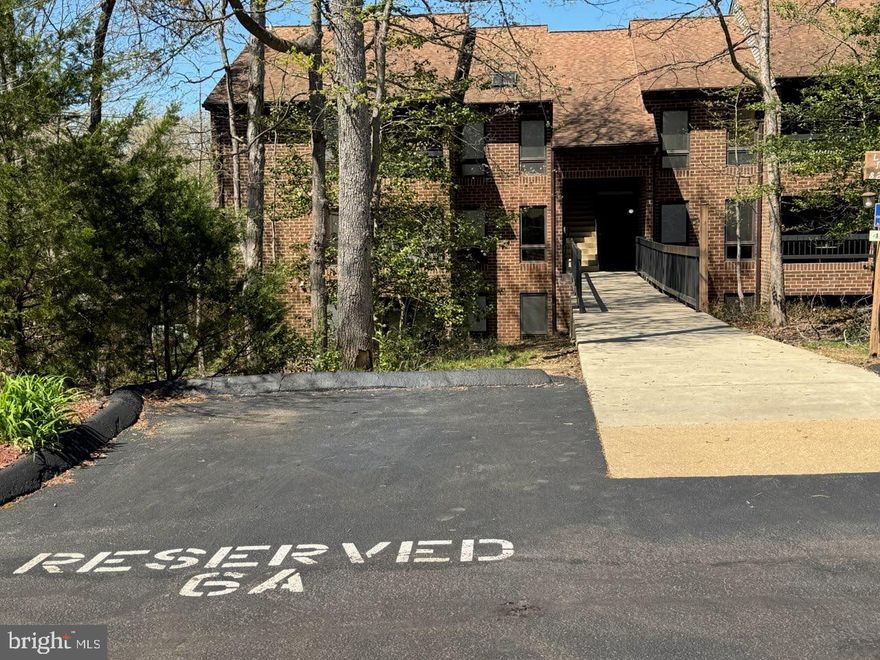 BRIDGE LEVEL Access - no steps! UNIT NUMBER ON DOOR IS #830. This Locust Ridge condo has beautiful views of the community pond an added amenities that other condo units in Wildewood don't offer such as in-unit sprinkler system, car washing station, and access to the pool and clubhouse. Condo dues are $240/mo and include trash and water utilities. The assigned parking is close to the condo and guest parking spots are also nearby. There are 2 BRs, 1.5 bathrooms. The primary bedroom has a WIC w/ attached half bath. The balcony overlooks the pond and offers a nice space to sit outside. Great investment property as bridge level units are in demand!