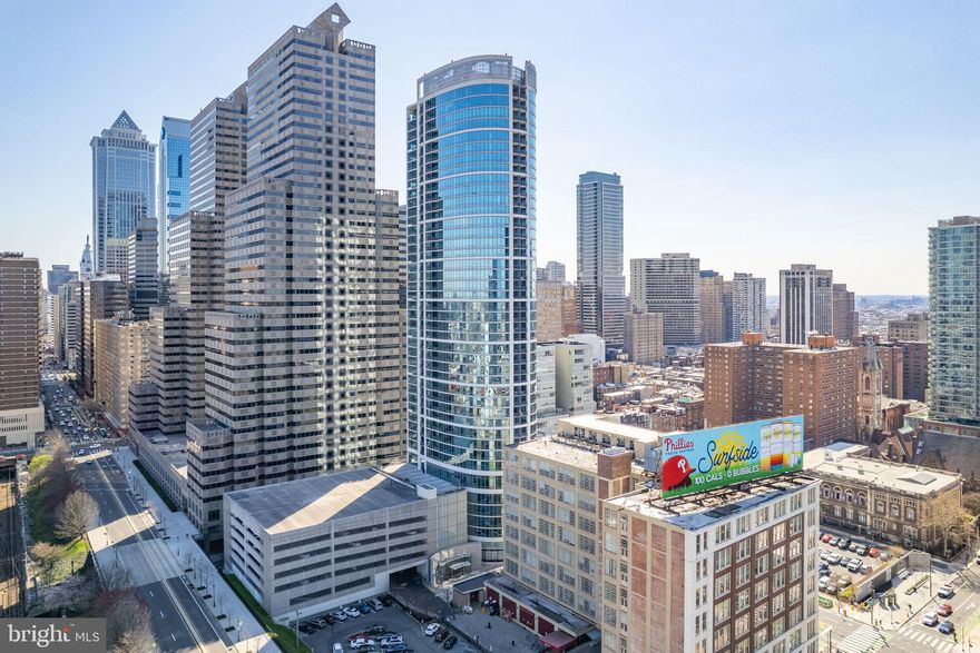 Enjoy luxury living and sweeping city views from one of the most desirable floor plans at the Murano condominium. This 1634 Sq./ft condo includes two bedrooms, three bathrooms, a dining room or office off the living room, a deeded parking spot in the attached garage, a 60 ft indoor heated swimming pool, a remodeled hospitality suite, and a main lobby, a state-of-the-art fitness center, and a landscaped sun deck. The open floor plan offers impressive southeast views, gleaming hardwood floors, a covered private balcony, and dramatic floor-to-ceiling windows throughout the condo. The open-concept kitchen has a large breakfast bar, imported cabinets, stainless steel appliances, and granite countertops. The bathrooms include tile floors and large vanities with storage. The Murano condominium is steps away from Rittenhouse Square, one-of-a-kind shopping, fine dining, 30th Street Station, the Schuylkill River Walking & Bike Path, Museums, Trader Joe's, Whole Foods, and more.