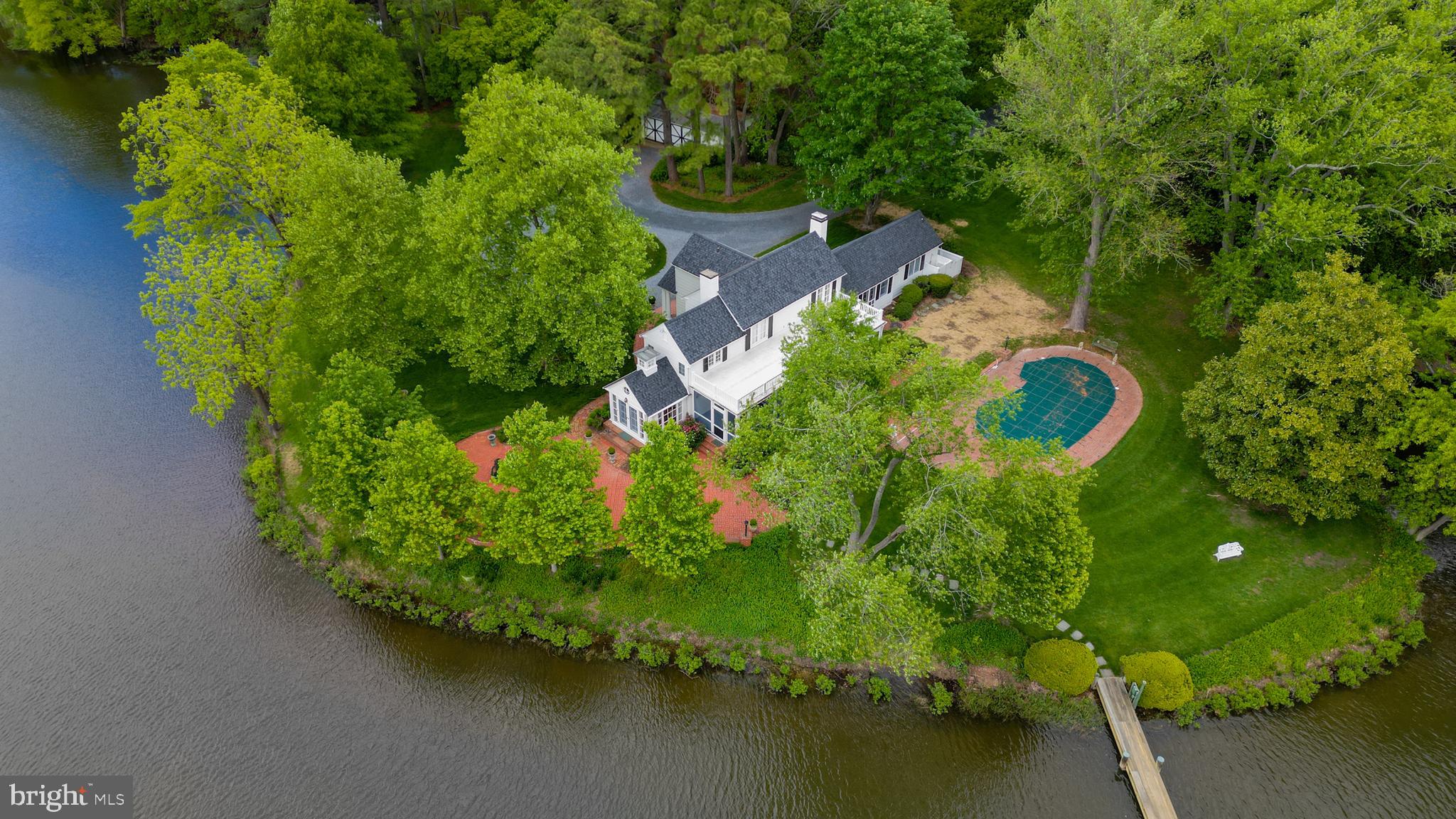 ​First time offered in over thirty years this meticulously maintained waterfront estate is ready for its next chapter, yours! The highly elevated, 3+/- acre of park-like grounds enjoys a approximately 600 feet of waterfront with westerly view over Maxmore Creek. Peaceful and serene, the well-manicured setting boasts a waterside pool and private pier. The interior of the home is traditional with formal living and dining areas, beautiful custom millwork from the crown molding to the built-in-bookcases and cabinetry. Ample kitchen with breakfast nook and a bright and sunny sitting/family/dining room with waterviews. Enjoy the screened porch in the summer and the sunroom whole year-round. Idyllically located between Easton and St Michaels by land and just a quick jaunt across the Tred Avon River to Oxford by water.